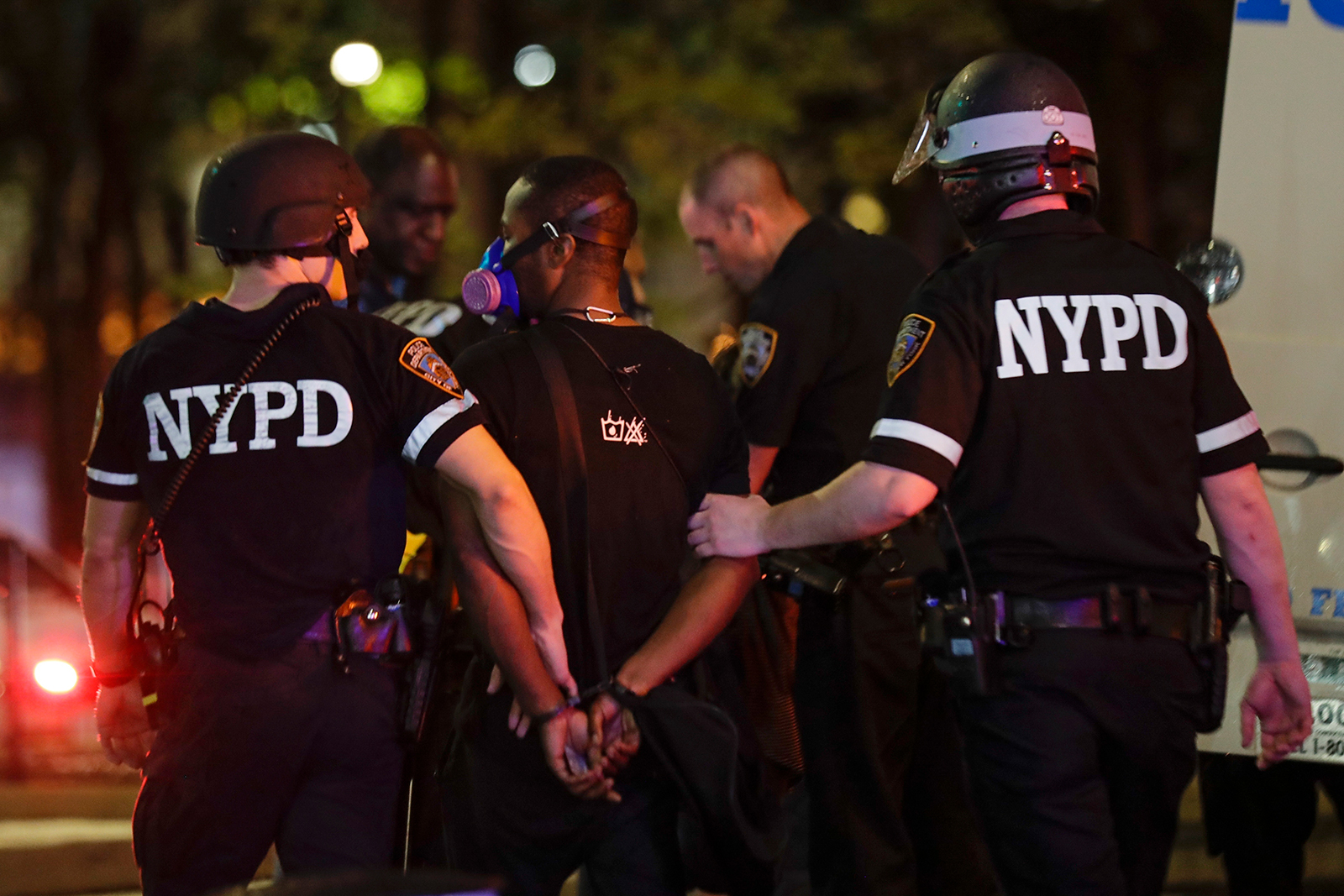 New York City police officers escort a protester after he was arrested at a rally on June 3, in the Brooklyn borough of New York.