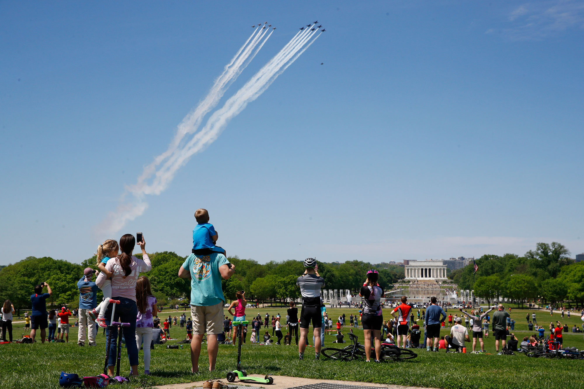 People watch the US Navy's Blue Angels and US Air Force Thunderbirds as they fly over the National Mall in Washington on Saturday, May 2. 