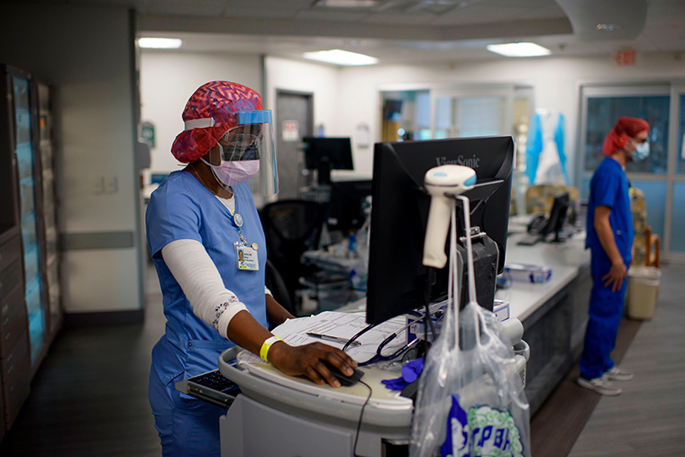 Registered Respiratory Therapist Niticia Mpanga looks through patient information in the ICU at Oakbend Medical Center in Richmond, Texas, on July 15. 