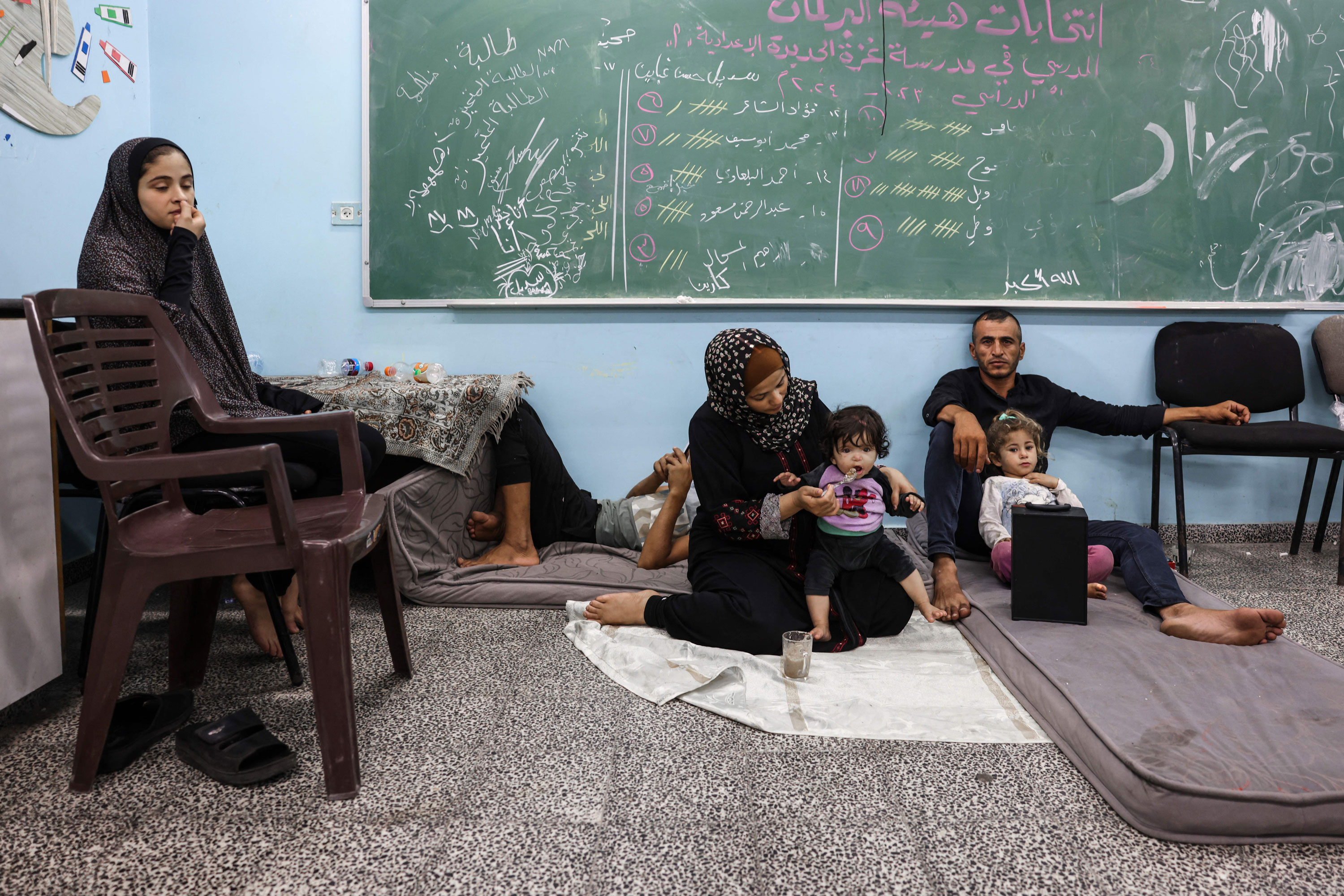 Palestinians fleeing Israeli air strikes take refuge in a school run by the United Nations in Gaza City on October 8, 2023.