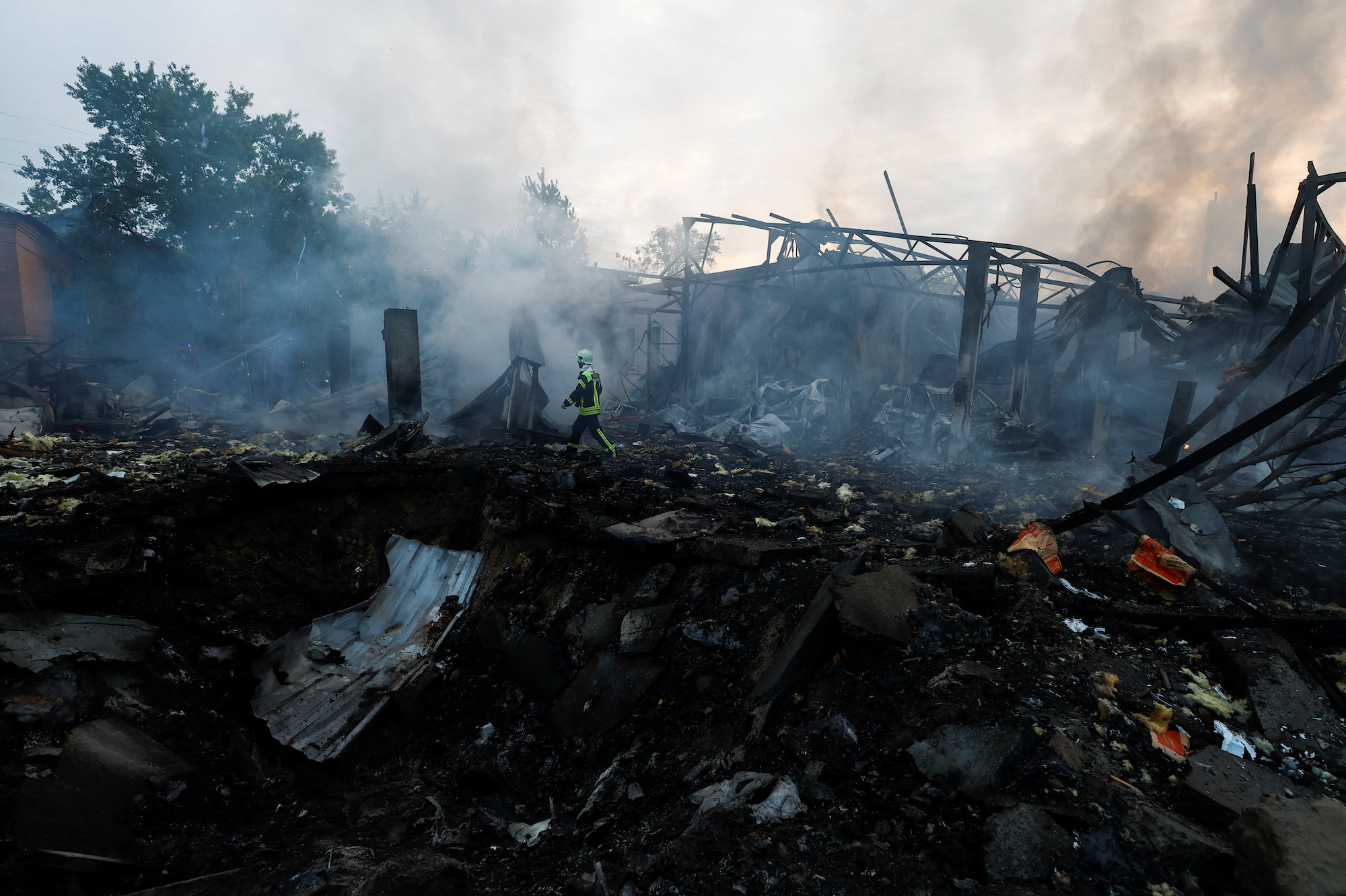 A firefighter works at a site damaged by a Russian missile strike in Kyiv on Thursday. 