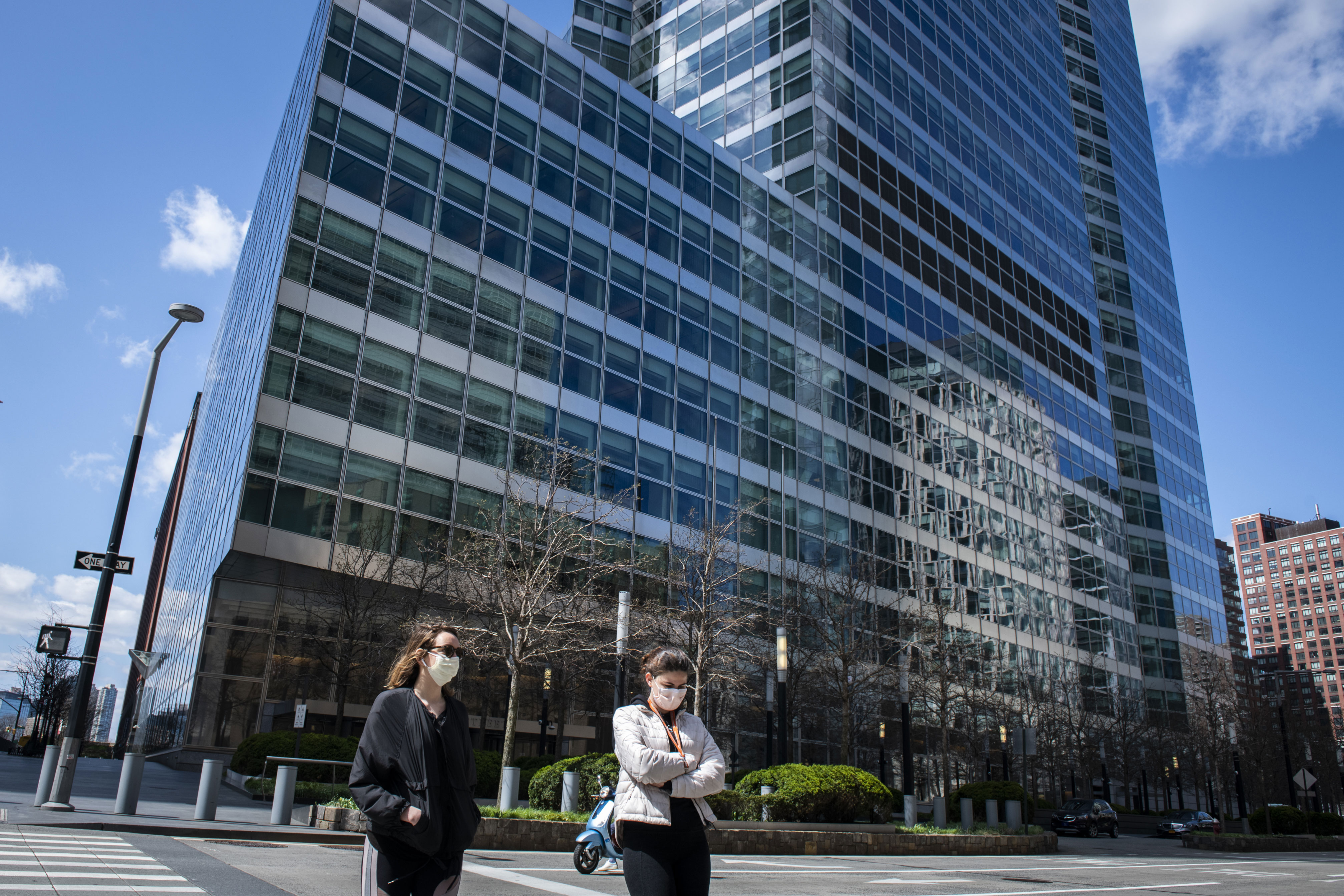 People walk by the Goldman Sachs headquarters in New York on April 11.