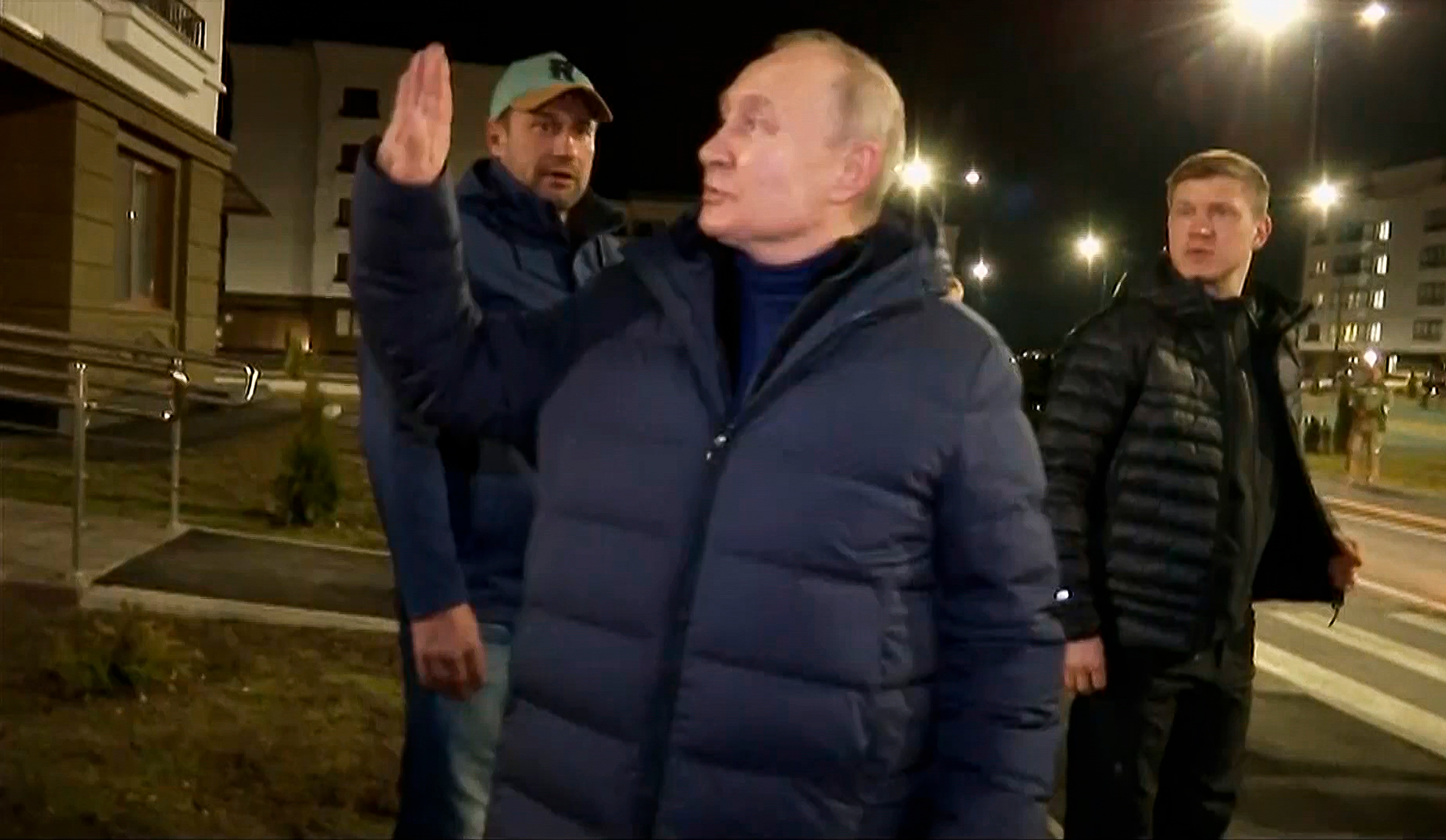 Russian President Vladimir Putin waves to residents in Mariupol, Ukraine, in a video released on March 19. 