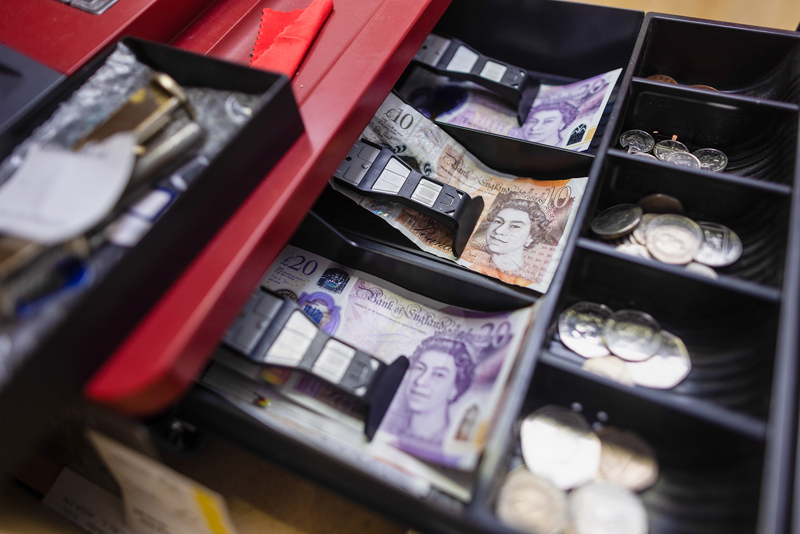 A cash tray holding British pound banknotes and coins in a shop in Barking, UK, on Tuesday, Sept. 13.
