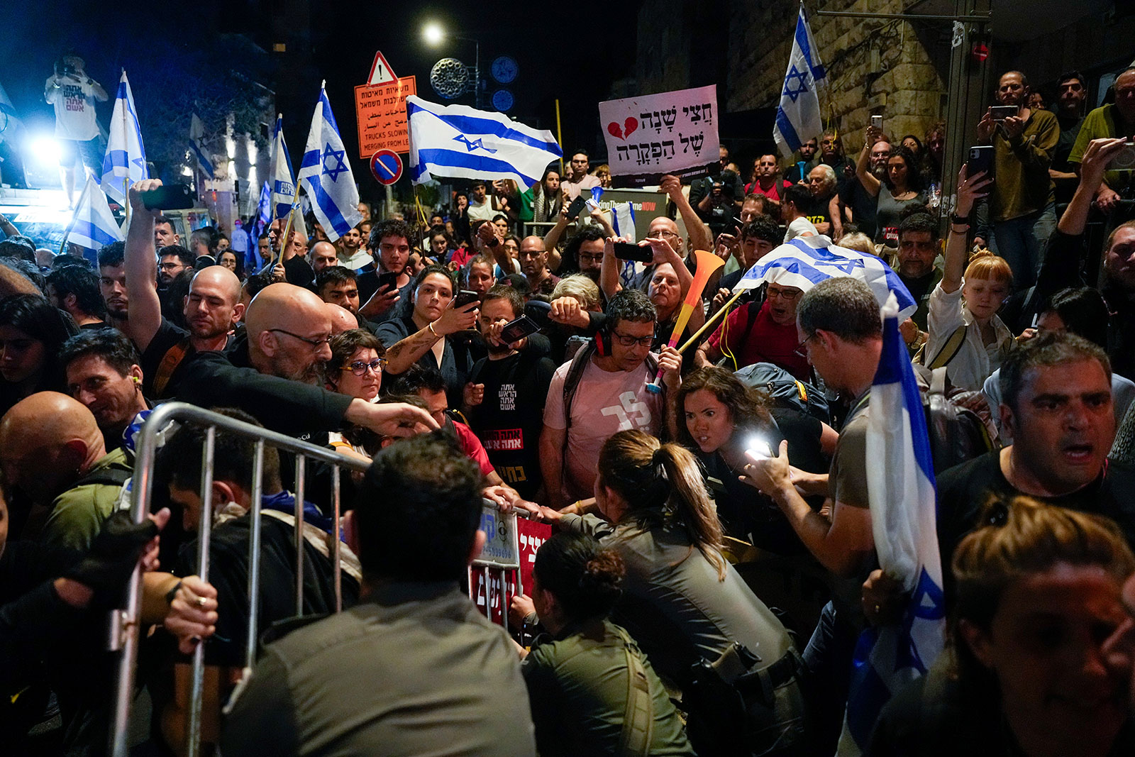 Police try to push back demonstrators protesting in Jerusalem, on Tuesday, April 2, against Israeli Prime Minister Benjamin Netanyahu's government and calling for the release of hostages held by Hamas.