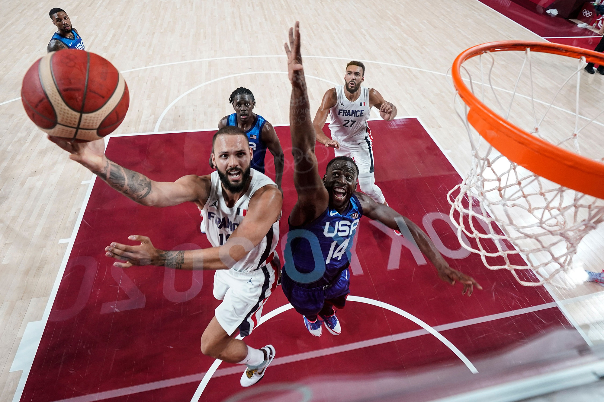 France's Evan Fournier goes for the basket past United States' Draymond Jamal Green during a basketball game on Sunday, July 25.