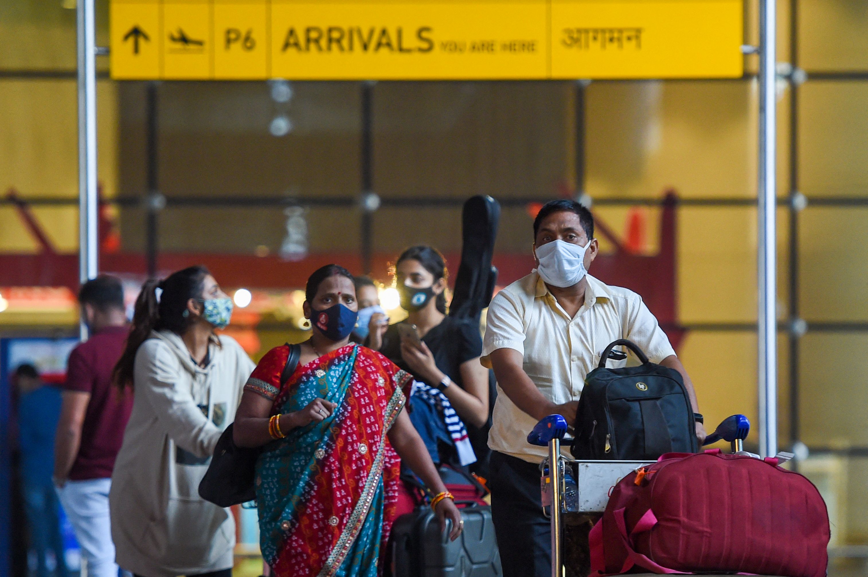Arriving passengers leave a terminal at the Chhatrapati Shivaji Maharaj International Airport in Mumbai on December 1, 2021. 