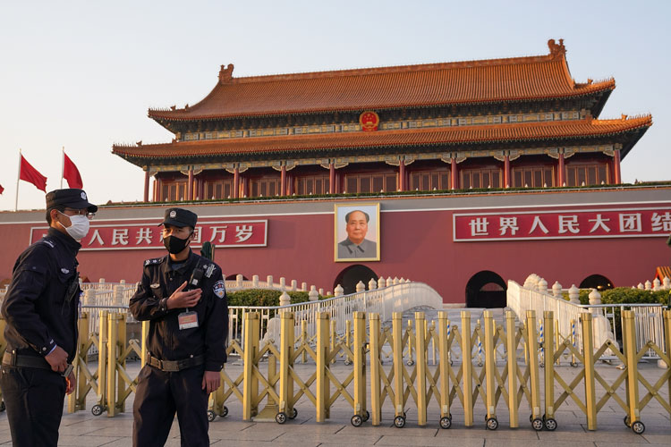 Chinese police officers wear protective masks in Beijing on March 16.