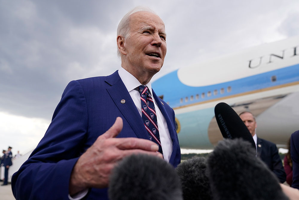 Biden talks with reporters as he boards Air Force One at Raleigh-Durham International Airport in Morrisville, North Carolina, on Tuesday, March 28.