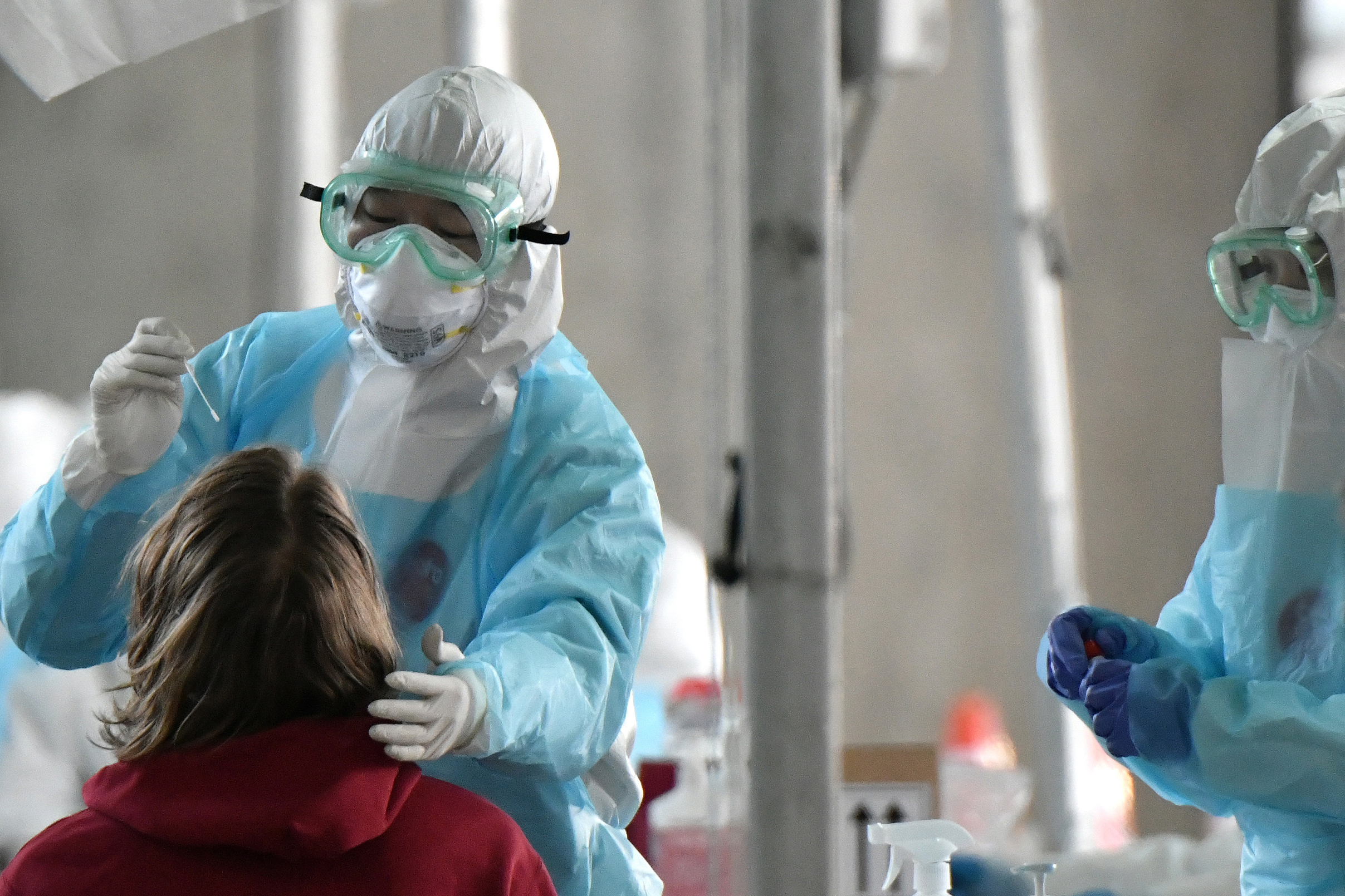 Medical staff test a foreign passenger for Covid-19 at a virus testing booth outside Incheon International Airport west of Seoul, South Korea, on April 1.