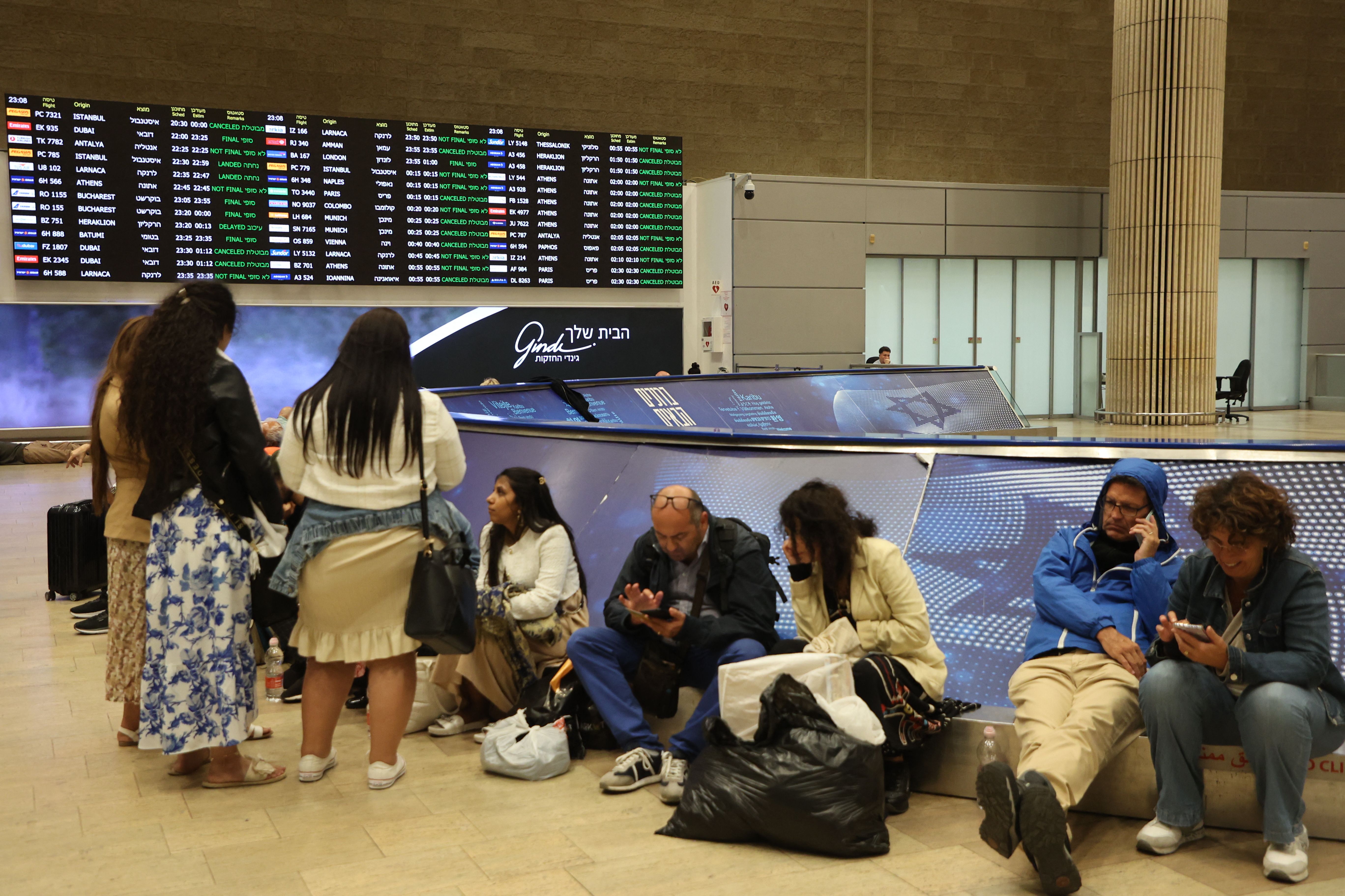 Passengers wait at Ben Gurion Airport near Tel Aviv, Israel, on October 7, 2023, as flights are cancelled because of the Hamas surprise attack.