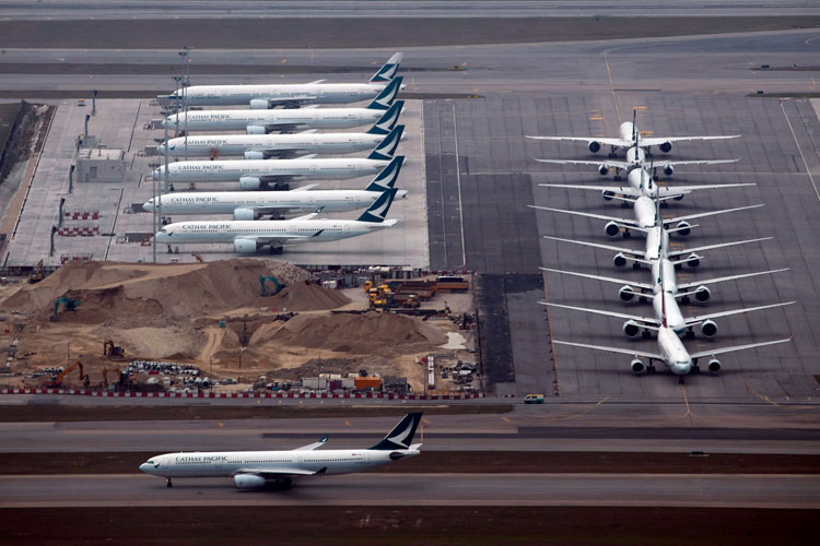 Cathay Pacific aircrafts line up on the tarmac at the Hong Kong International Airport, Friday, March 6 The global airline's flying schedules have declined since the outbreak of new coronavirus.