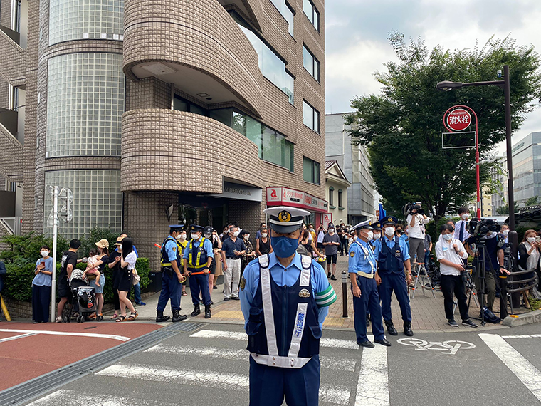Police officers stand guard near the Abe family home in Tokyo on Saturday.