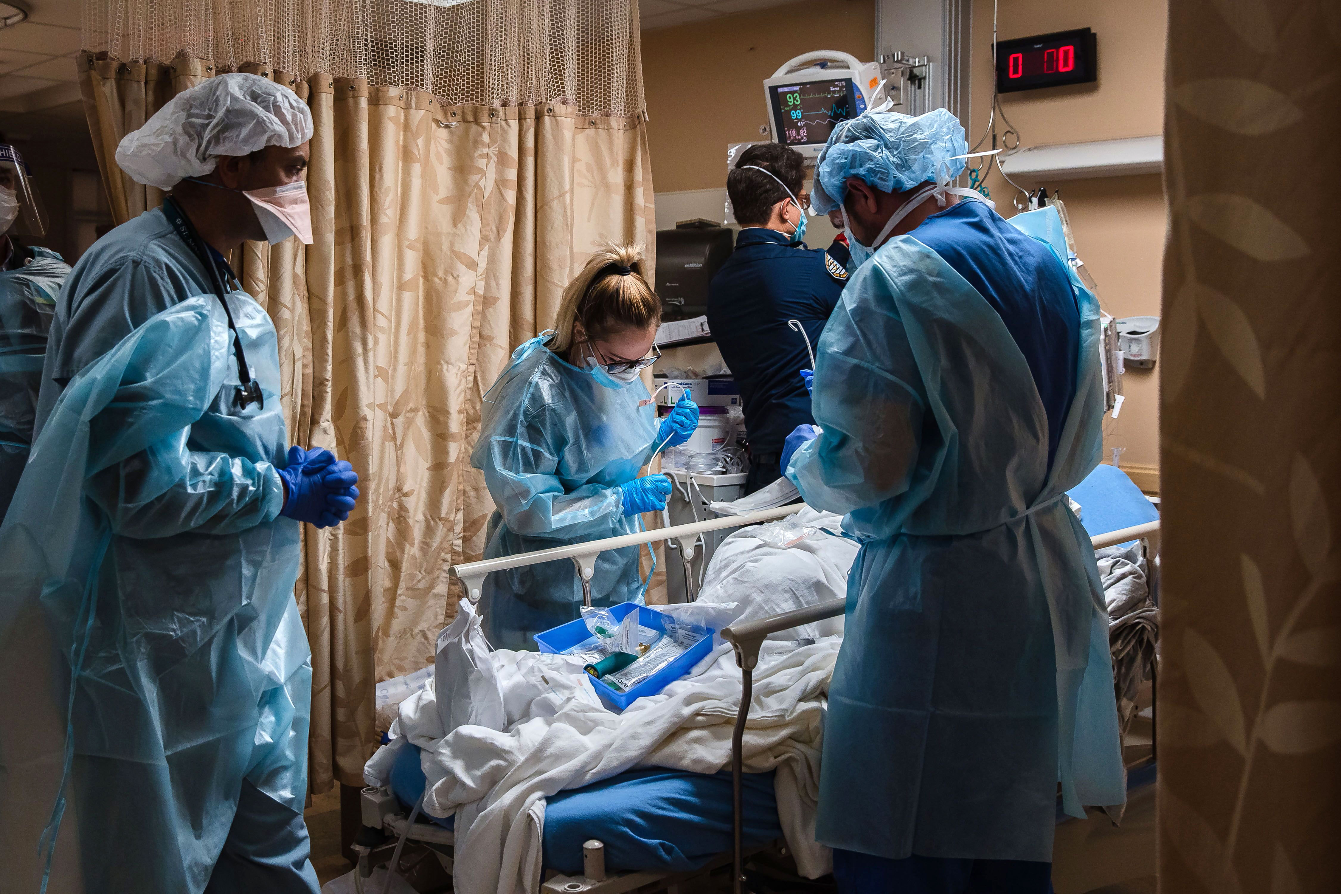 Health care workers tend to a patient with Covid-19 who is having difficulty breathing at Providence St. Mary Medical Center in Apple Valley, California, on January 11.