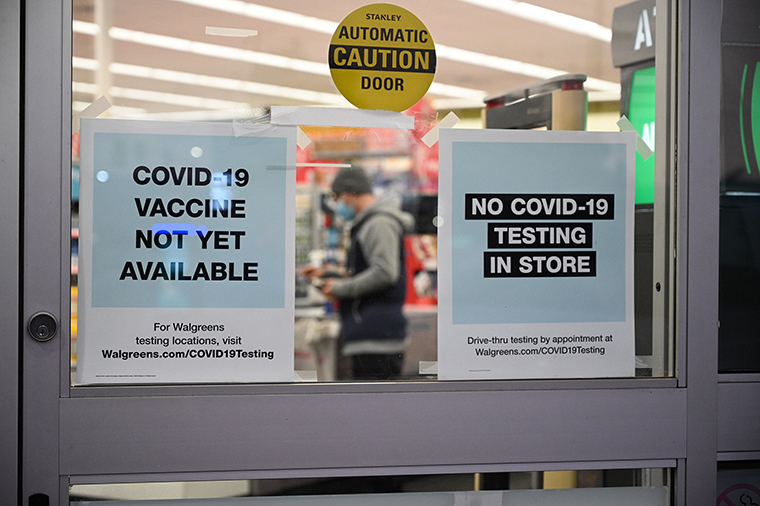 A sign on the entrance to a pharmacy reads "Covid-19 Vaccine Not Yet Available", November 23, 2020 in Burbank, California. 