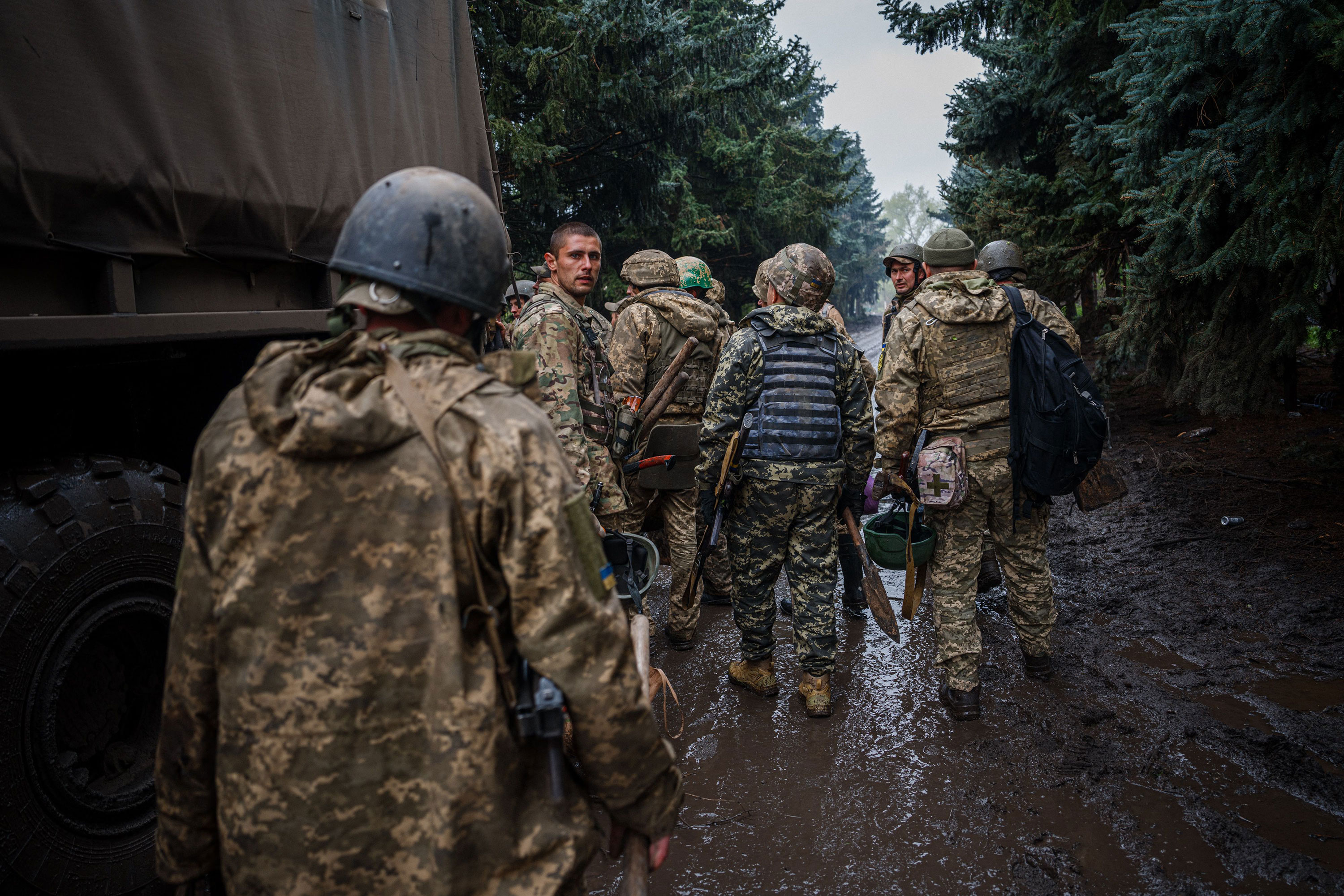Ukrainian servicemen gather at a military truck near Bakhmut, on Sunday.