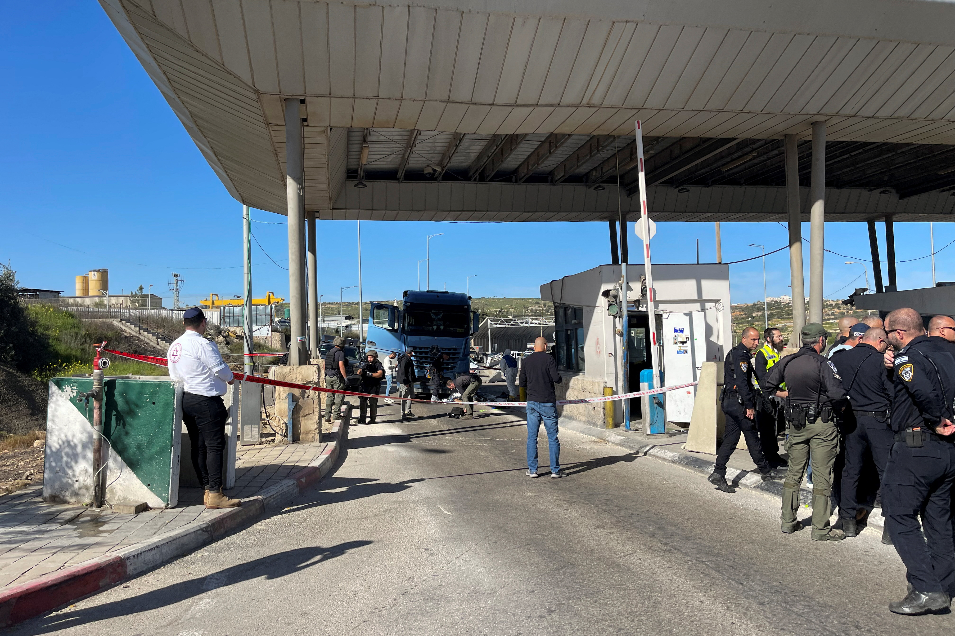 Israeli forces work at the scene of a suspected attack at a checkpoint outside of Jerusalem, in the Israeli-occupied West Bank, on March 13.