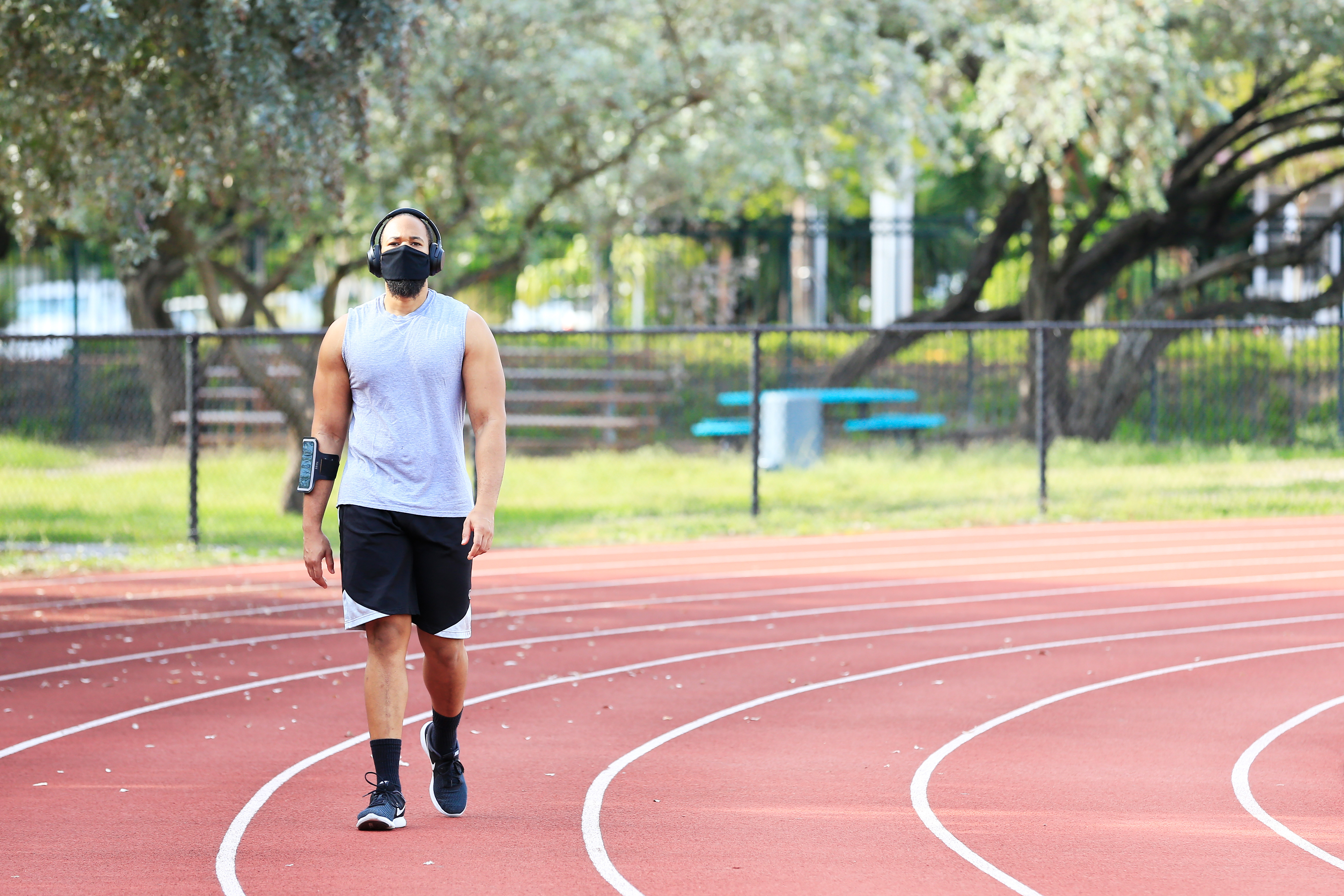 A man wearing a face mask exercises on the track in Flamingo Park on April 29 in Miami Beach, Florida.