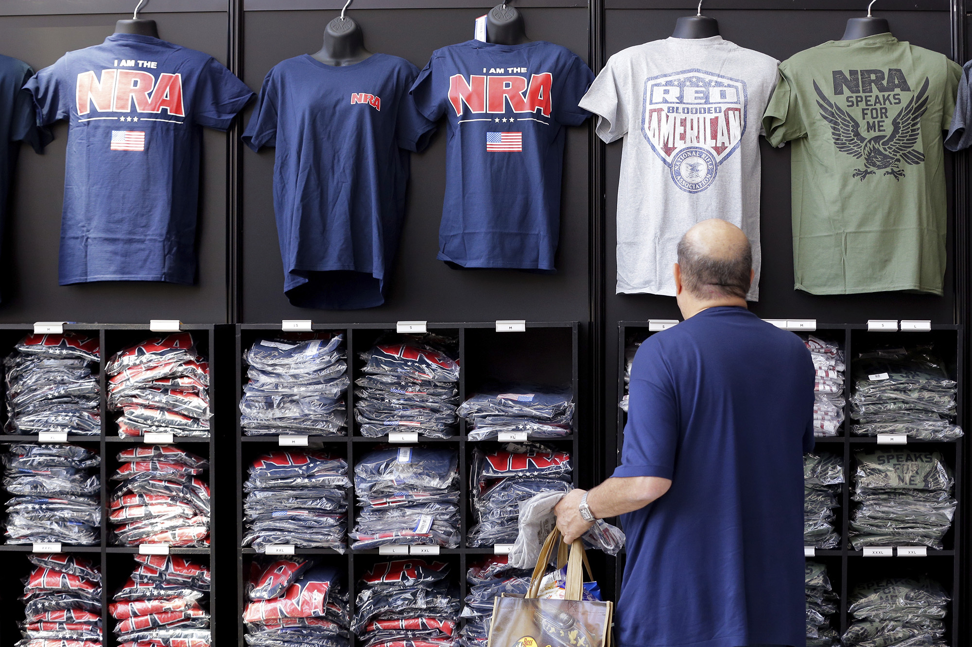 A convention attendee looks at NRA branded shirts for sale at the NRA Store at the NRA Annual Meeting held at the George R. Brown Convention Center on May 26, in Houston, Texas.