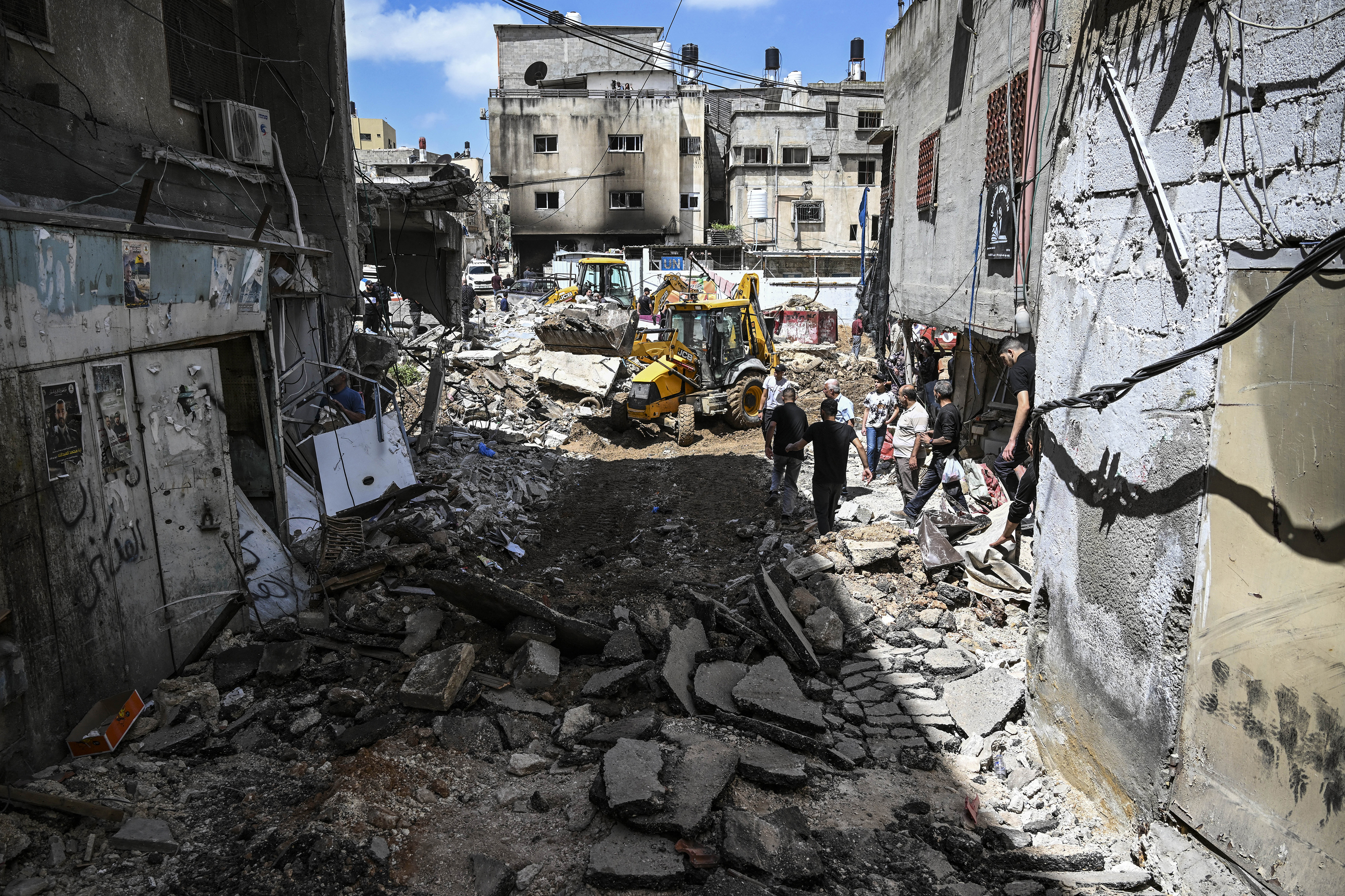 People inspect damage after a raid by Israeli forces in the Nur Shams refugee camp in the occupied West Bank on April 21.
