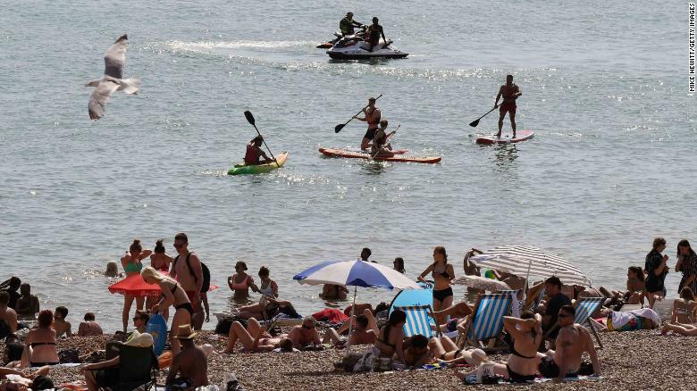 Many flocked to the beach to cool down in Brighton, southern England on Tuesday.