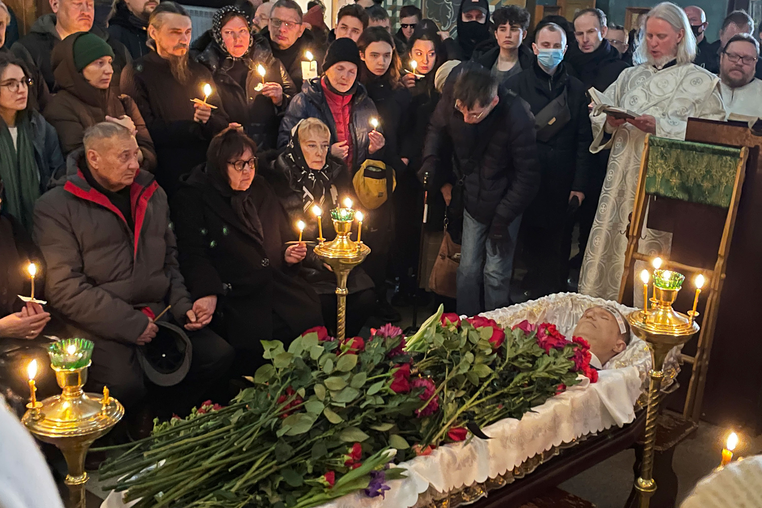 Alexey Navalny's father and mother, left, are joined by others as they pay their last respects during his funeral in Moscow on Friday.