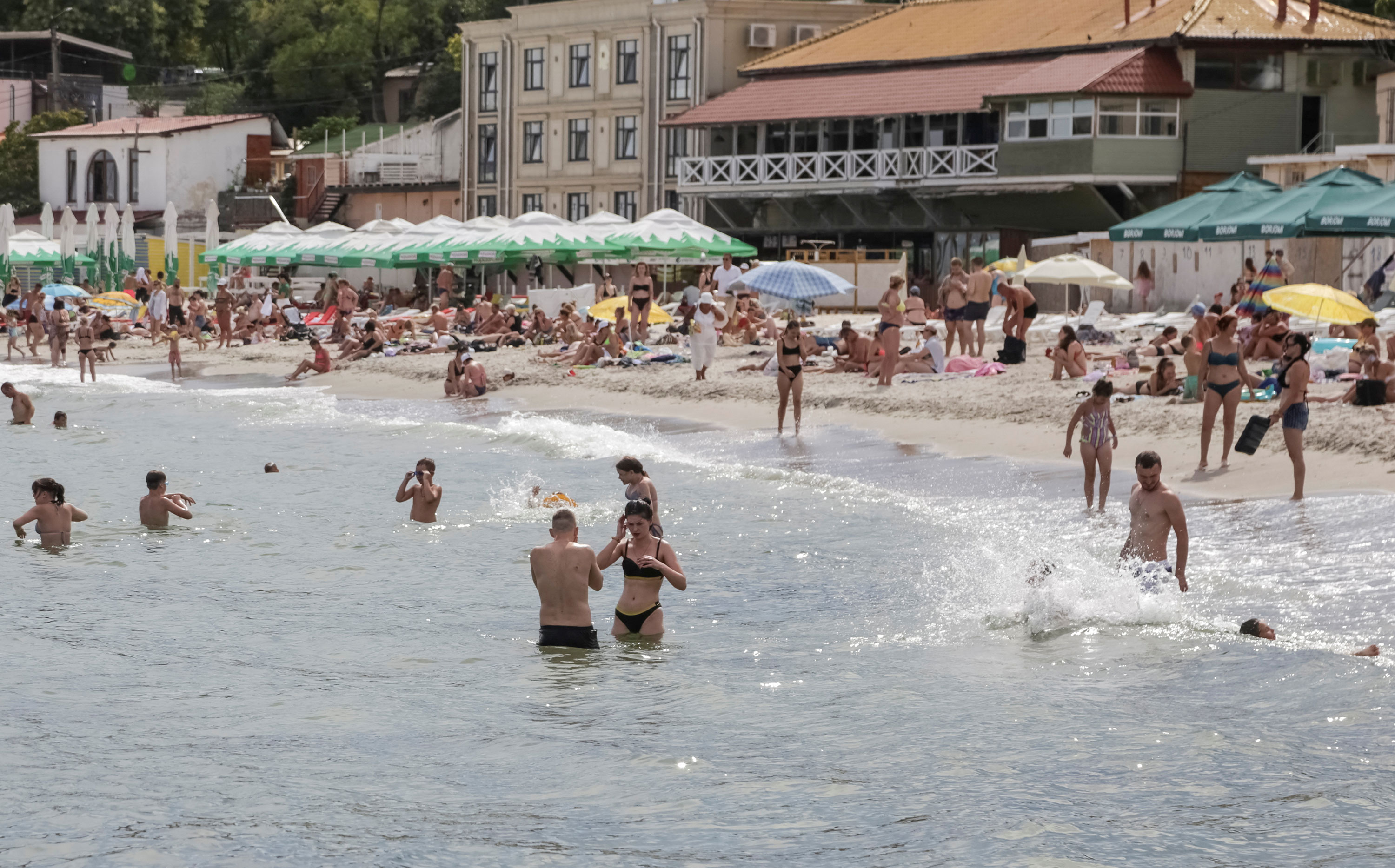 People visit a Black Sea beach that was reopened after being closed down last year in Odesa on August 10. 
