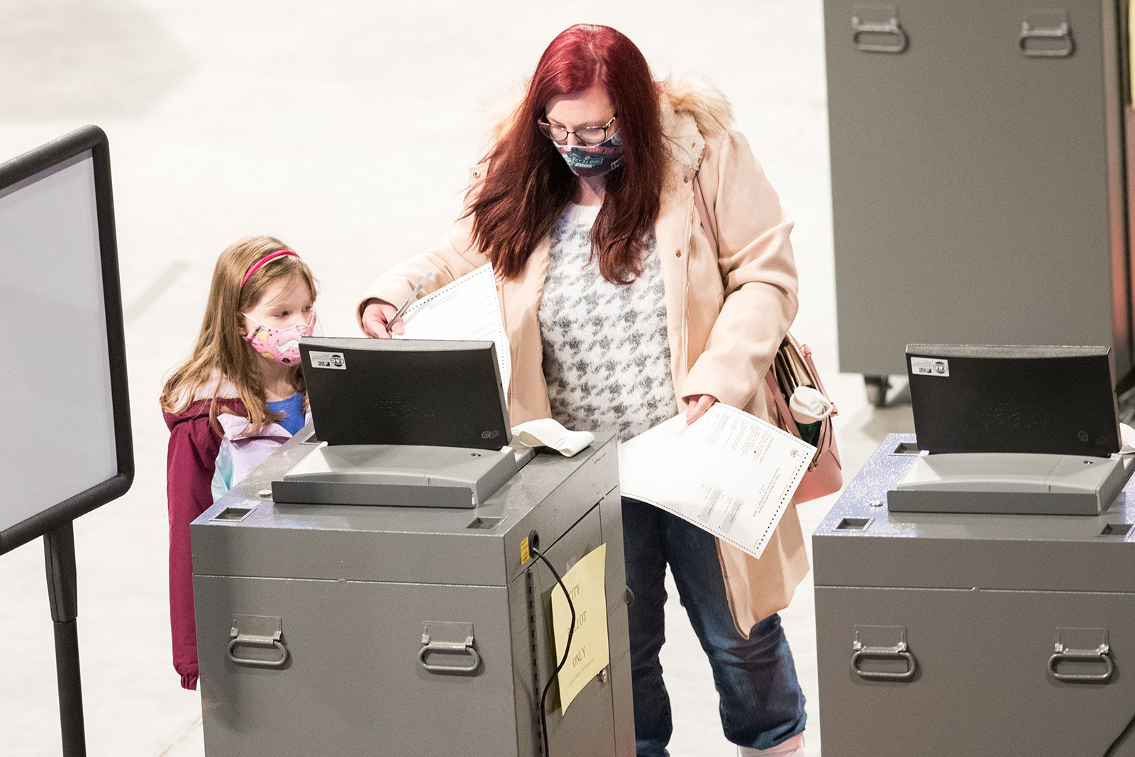 A woman casts her ballot at the Cross Insurance Center polling location on November 3, in Bangor, Maine. 