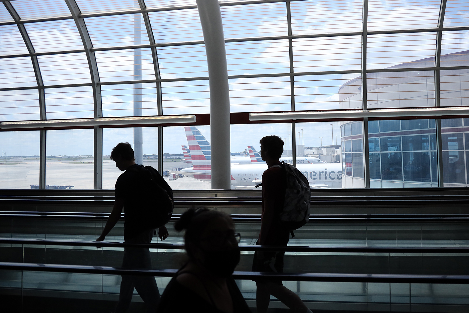 Passengers walk between terminals at Charlotte Douglas International Airport on May 15, in Charlotte, North Carolina.