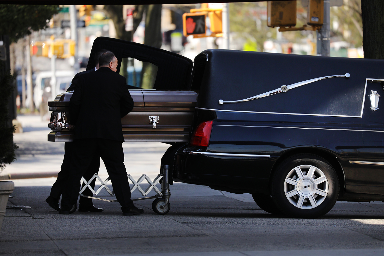 A casket is placed into a hearse outside of a funeral home in New York City on April 16.