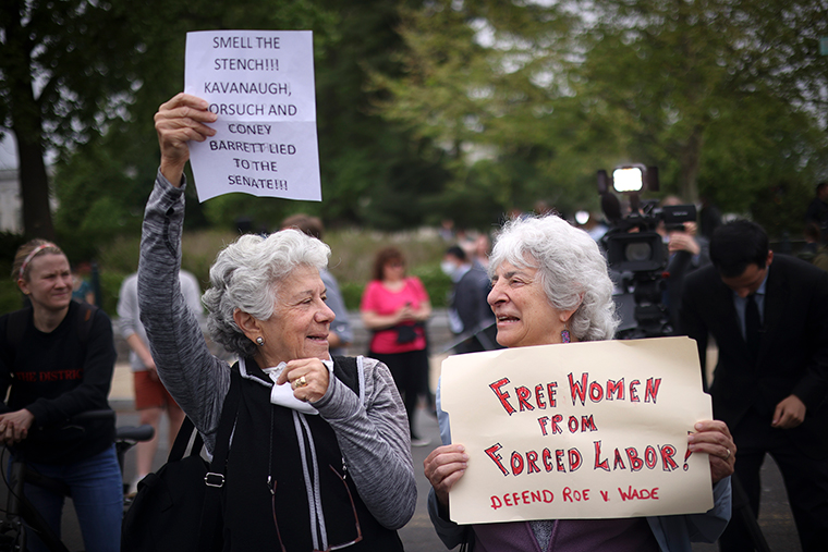 Roberta Shapiro, left, and Kim Fellner demonstrate in front of the U.S. Supreme Court Building