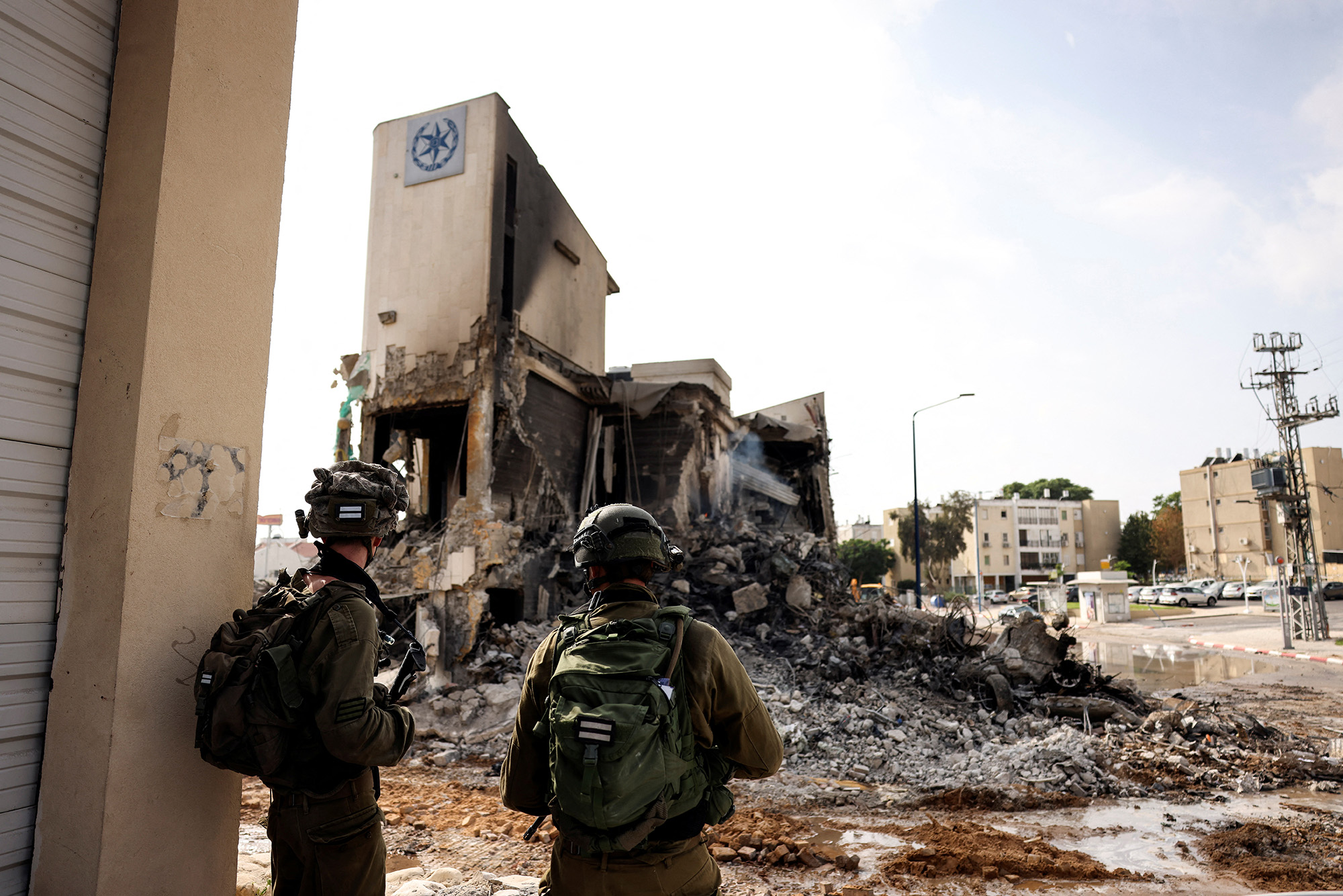 Israeli soldiers look at the remains of a police station which was the site of a battle with Hamas gunmen in Sderot, southern Israel, on October 8.