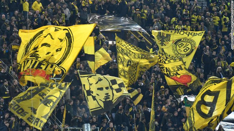 Dortmund fans wave flags prior to the UEFA Champions League round of 16 second-leg football match Tottenham Hotspur on March 5, 2019 in Dortmund, western Germany.