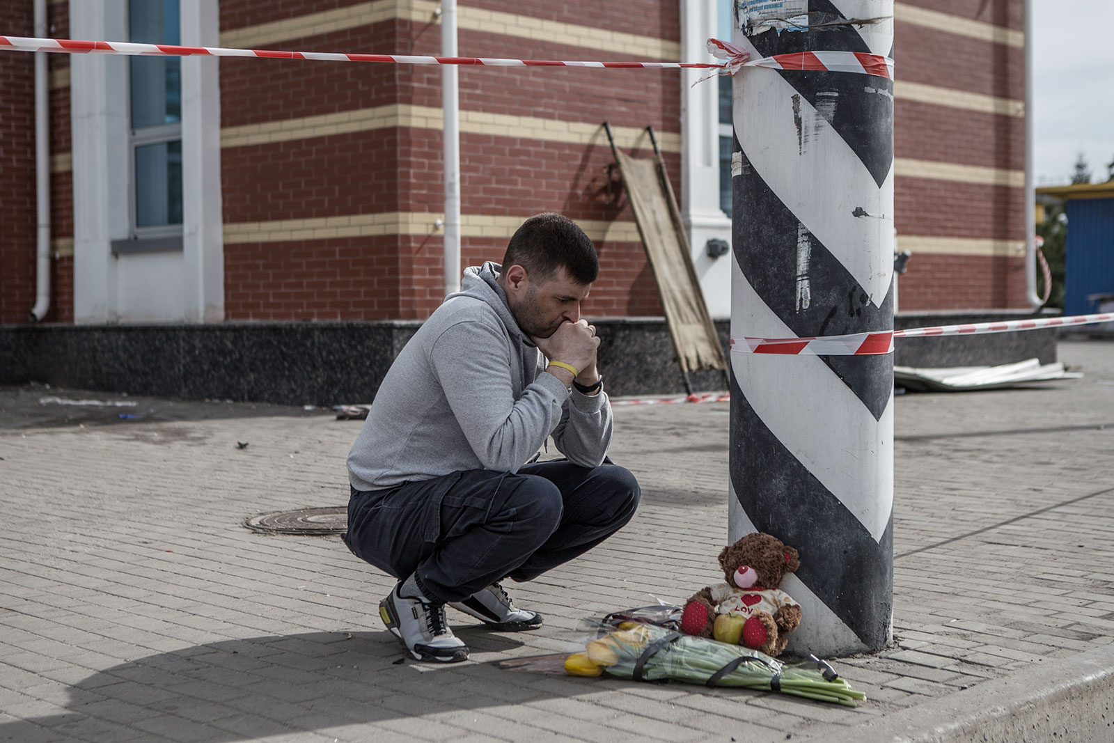 A man lays flowers at the Kramatorsk railway station after the Russian missile strike in Kramatorsk, Ukraine, on April 9.