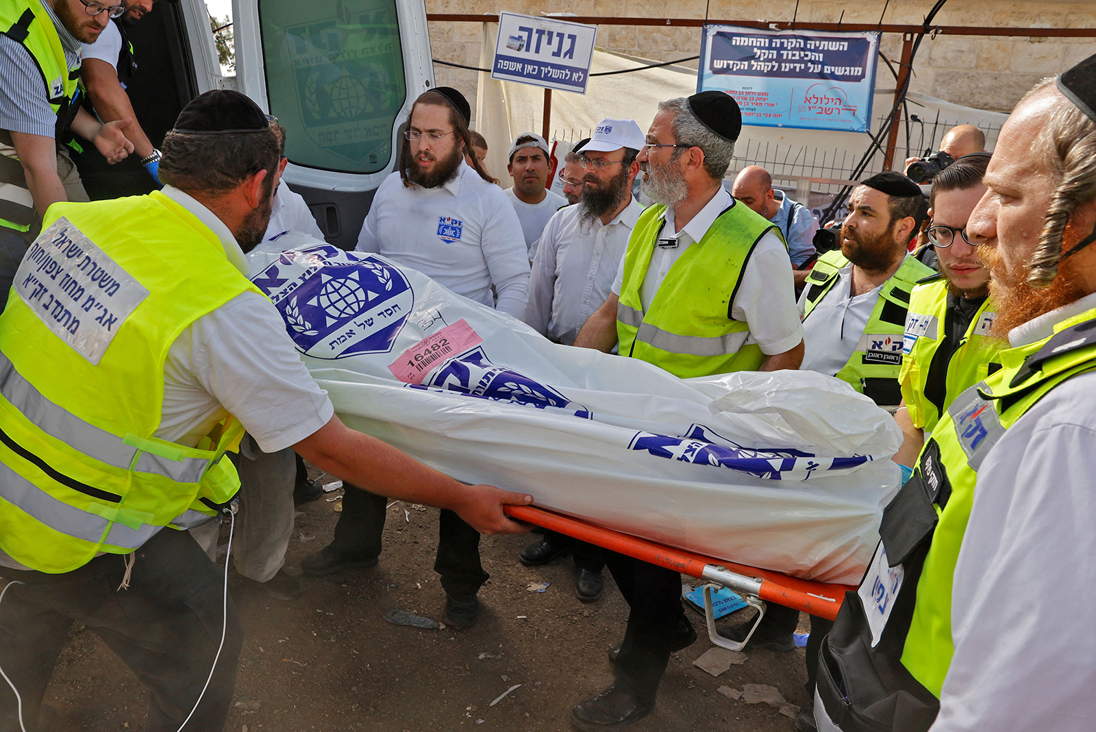 Israeli rescue teams carry a body bag into an ambulance in Meron, Israel, on April 30.