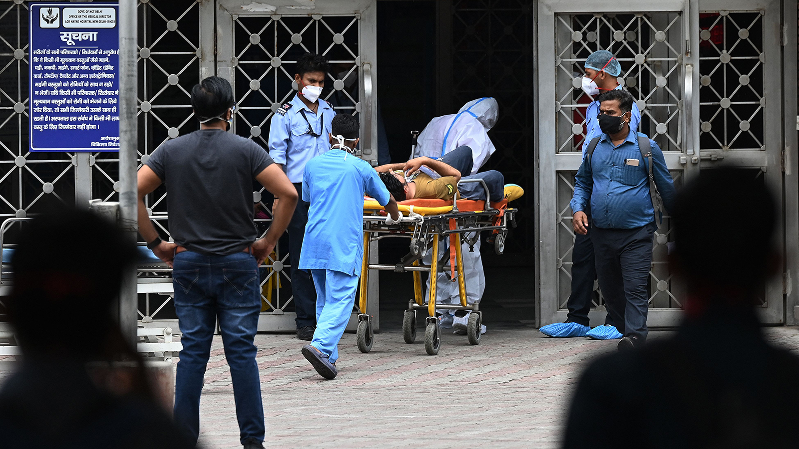 Medical staff transfer a Covid-19 patient to a hospital in New Delhi on May 18.