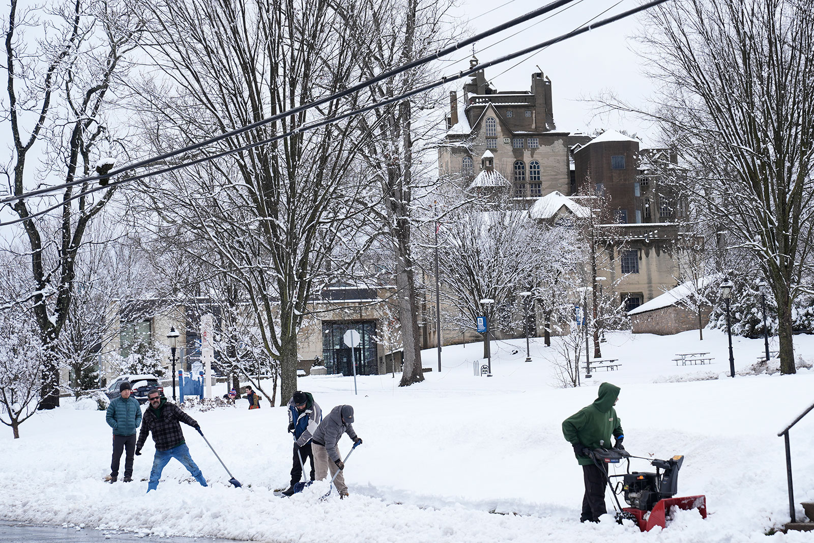 A crew clears snow from a sidewalk in Doylestown, Pennsylvania, on Tuesday.