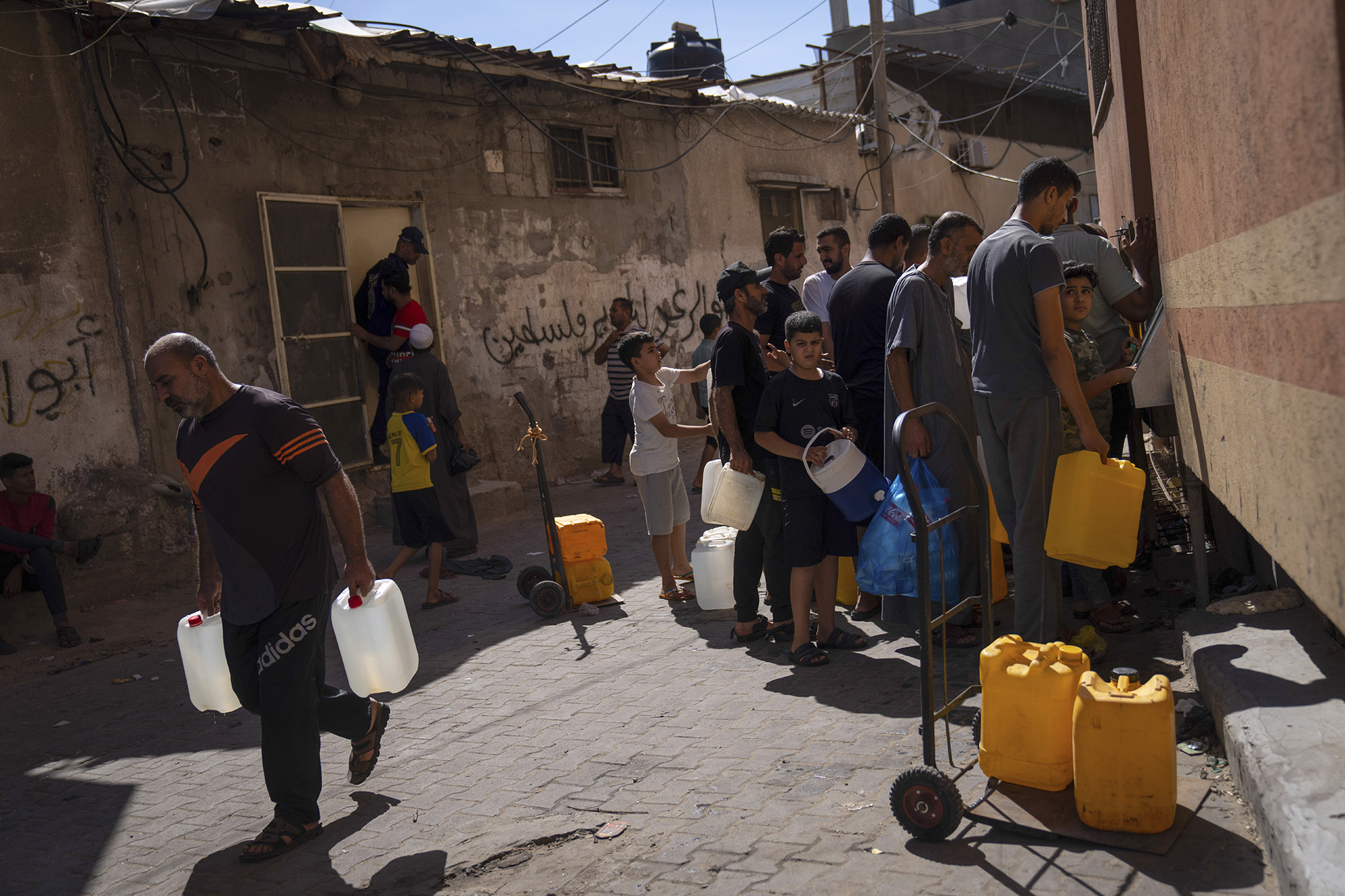 Palestinians collect water from a water tap in Khan Younis, Gaza Strip, on October 15.