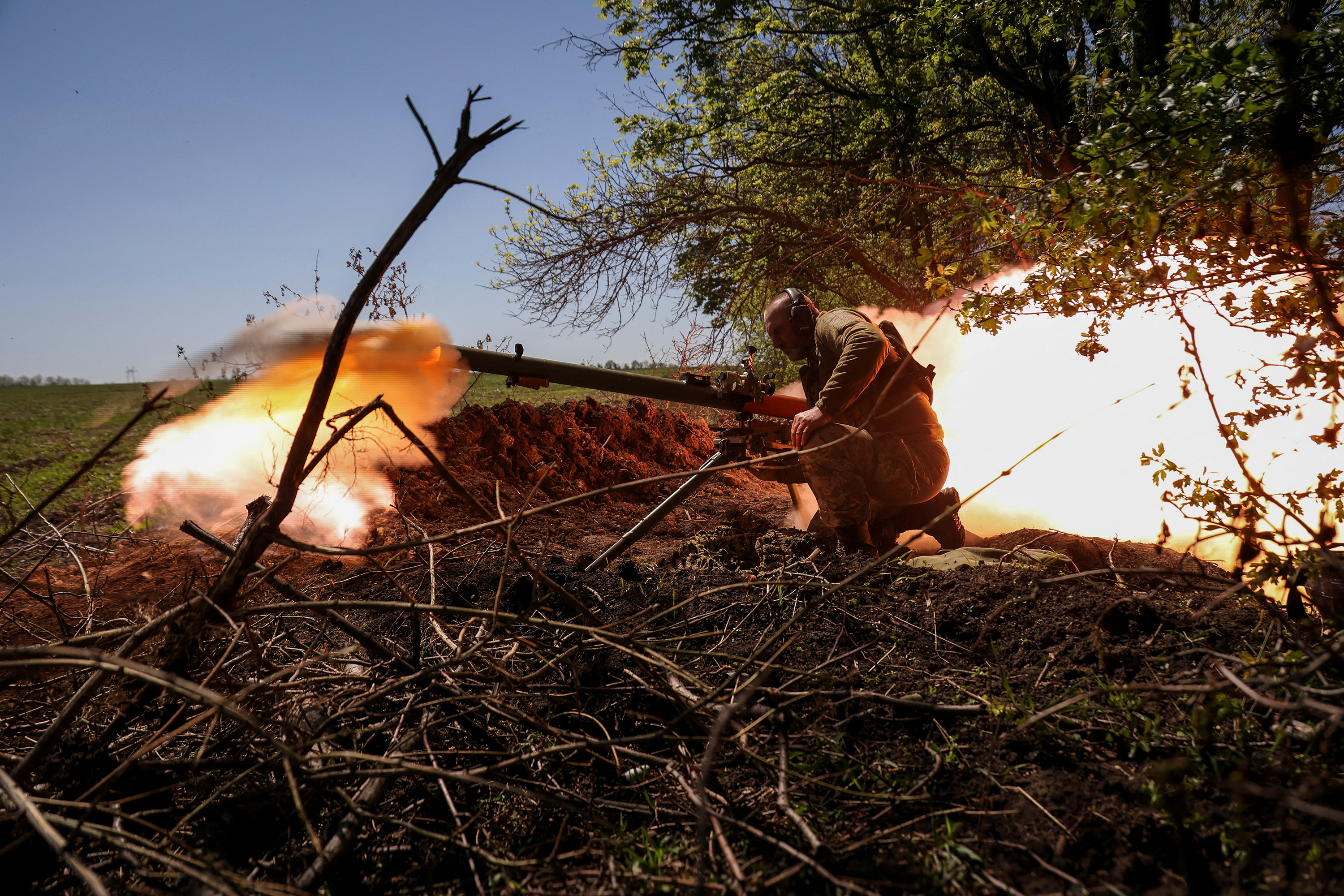 A Ukrainian service member fires an anti-tank grenade launcher at a front line, amid Russia's attack on Ukraine, near the city of Bakhmut, Ukraine, on May 3.