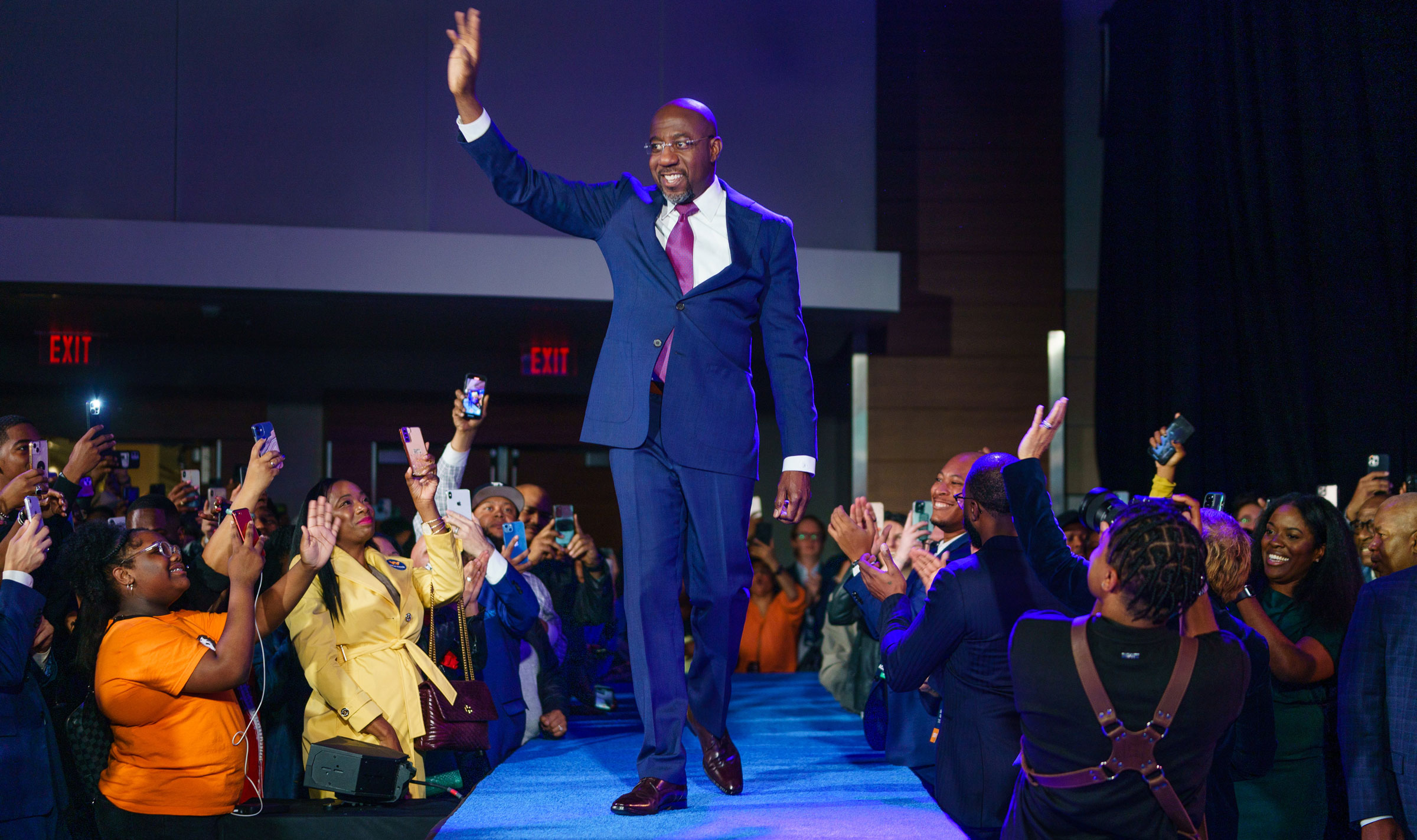US Senator Raphael Warnock walks on stage at his election night event in Atlanta on Tuesday.