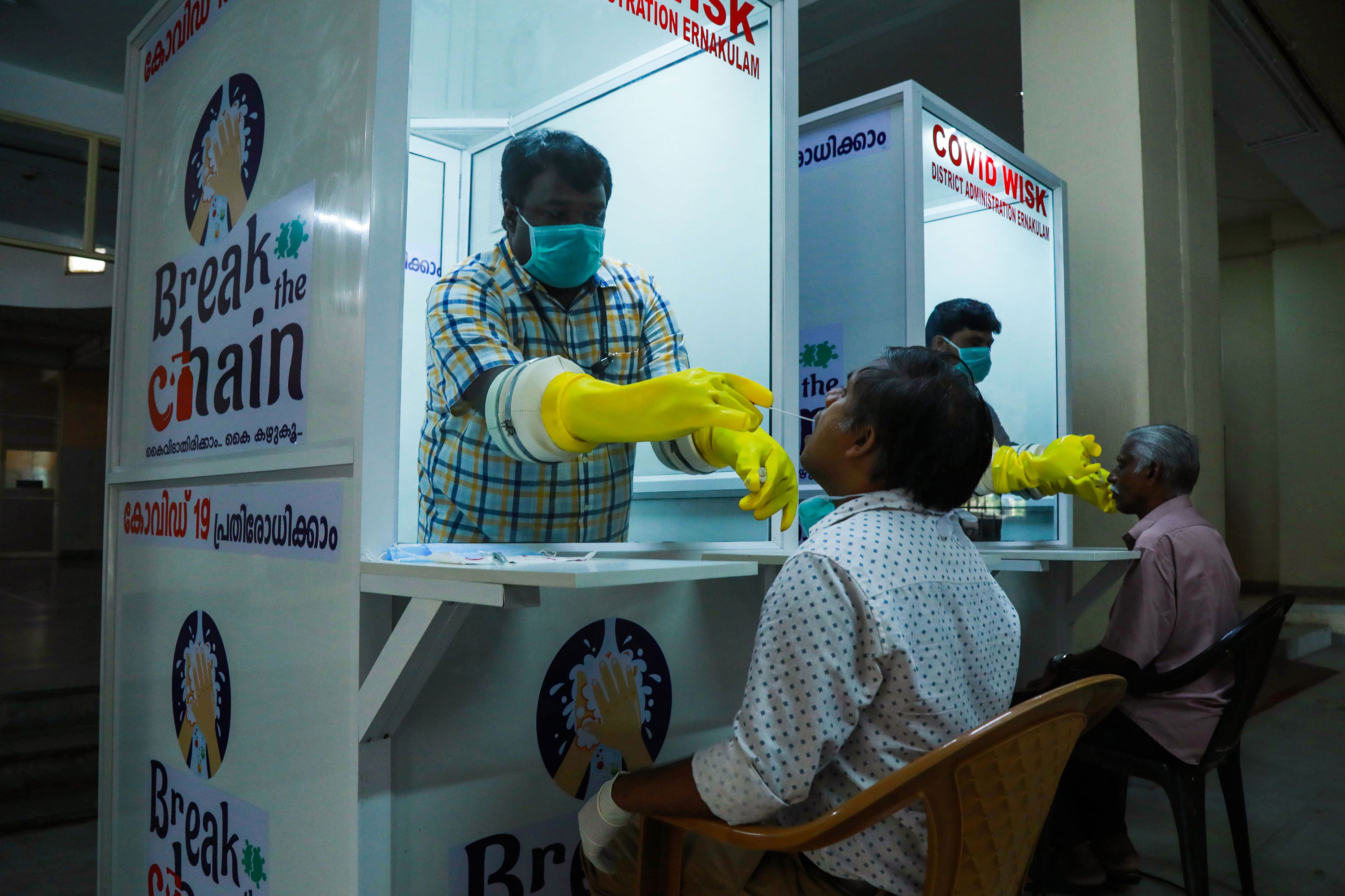 Medical staff collect coronavirus test samples at Ernakulam Medical College in Kerala, India, on April 6.