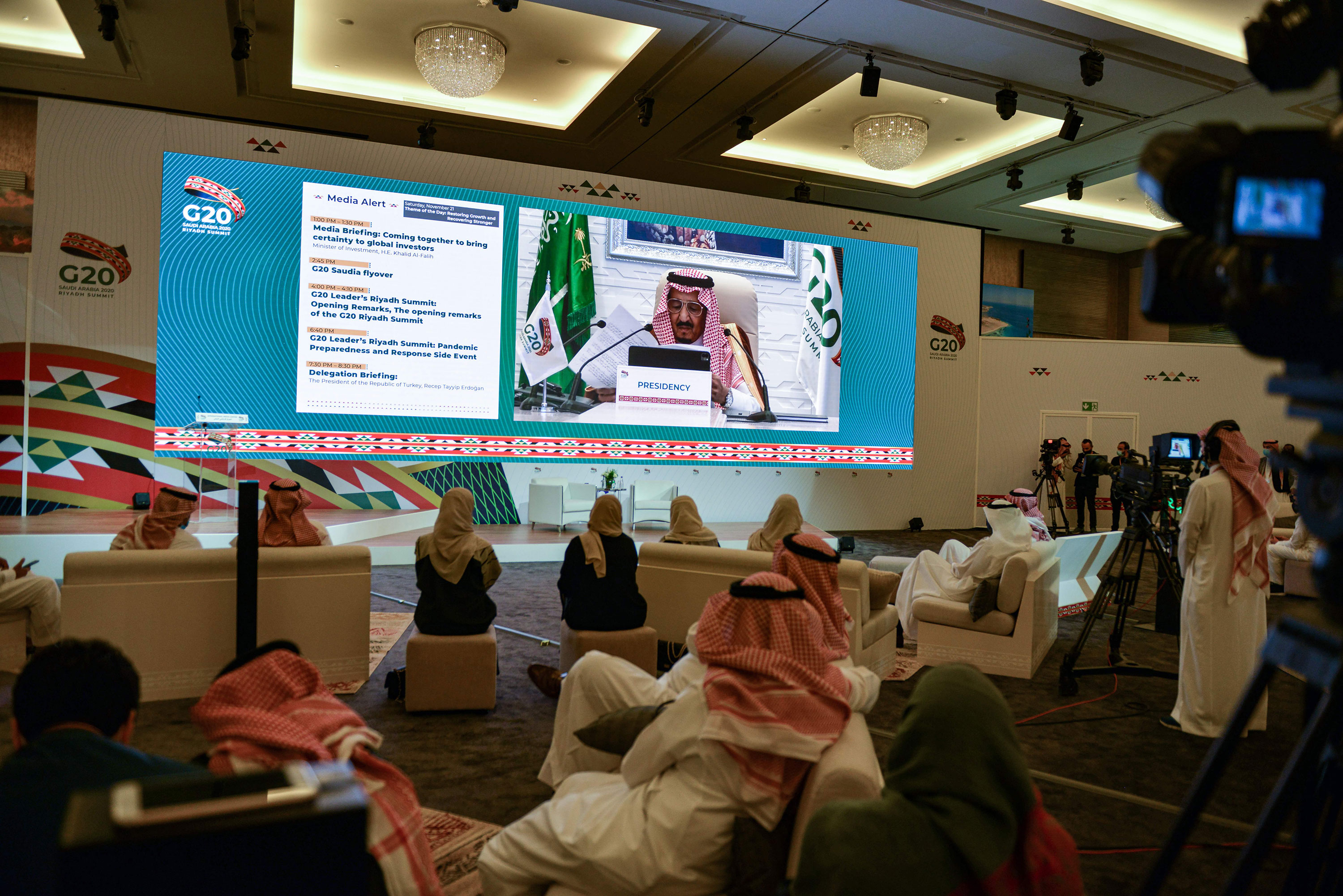 Members of the media watch on a projected screen at the International Media Centre in Saudi Arabia's capital Riyadh as Saudi King Salman bin Abdulaziz gives an address opening the G20 summit on November 21.