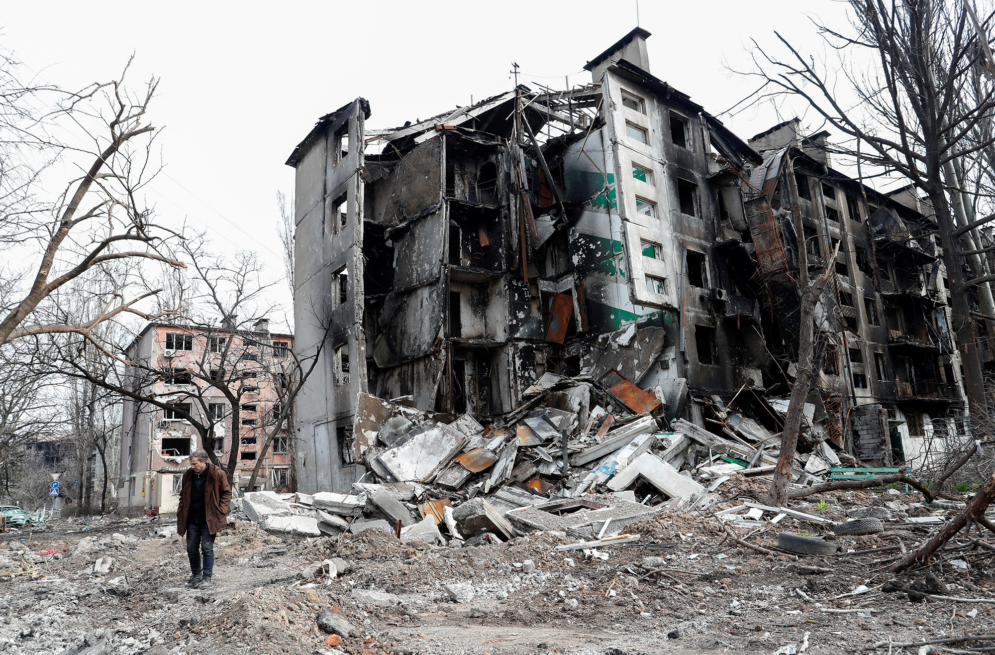 A man walks near a destroyed residential building in the southern port city of Mariupol, Ukraine, on April 17.