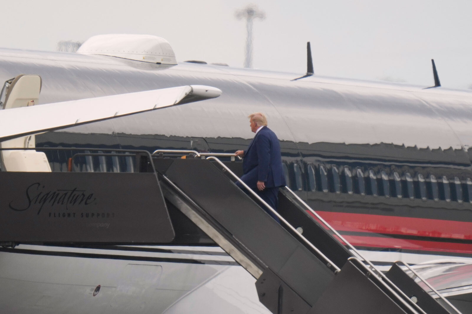 Former President Donald Trump boards his plane at Newark Liberty International Airport in Newark, New Jersey, on Thursday.