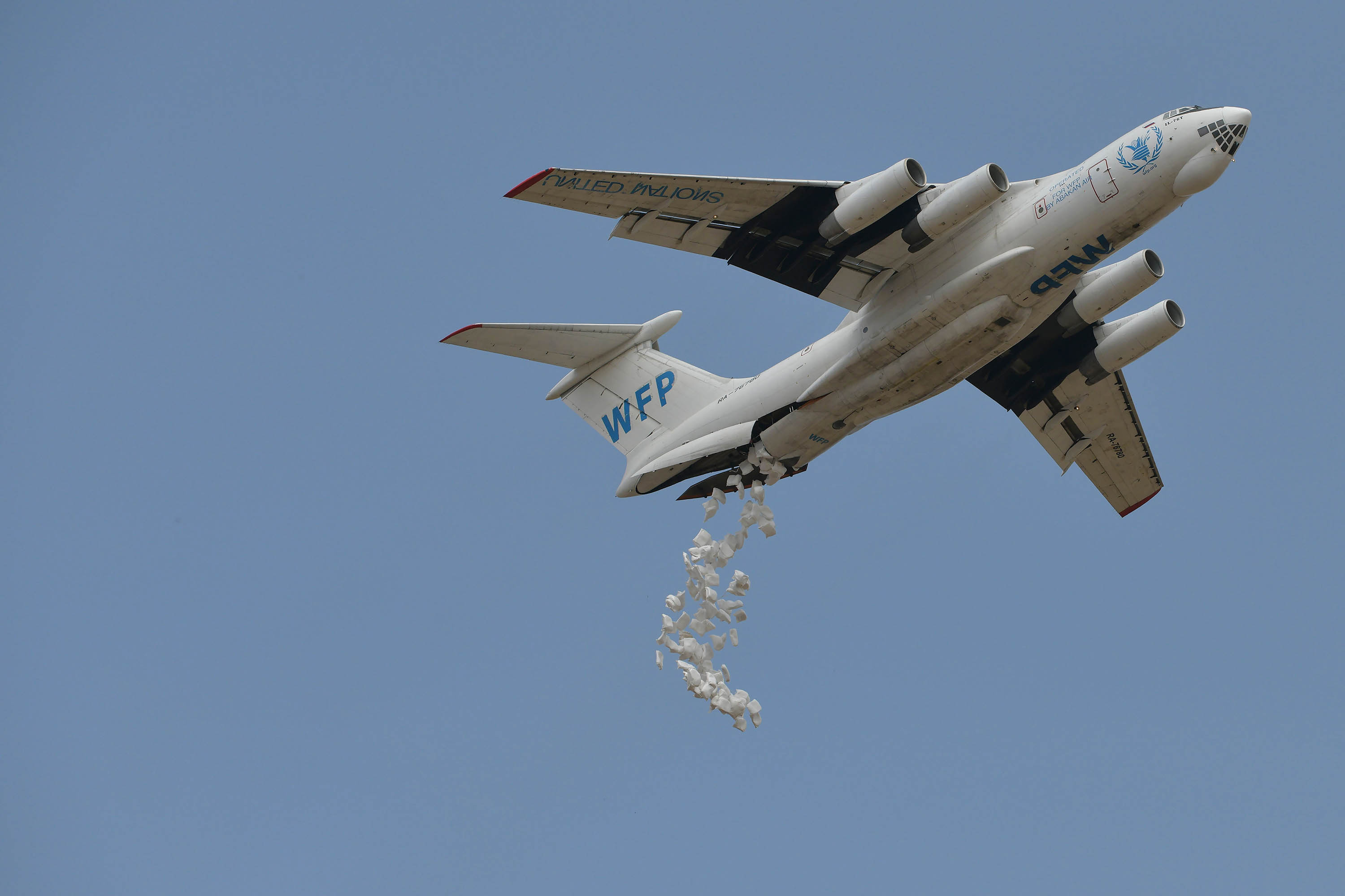 A plane leased to the World Food Programme (WFP) makes a drop of food aid near a village in Ayod county, South Sudan, on February 6.