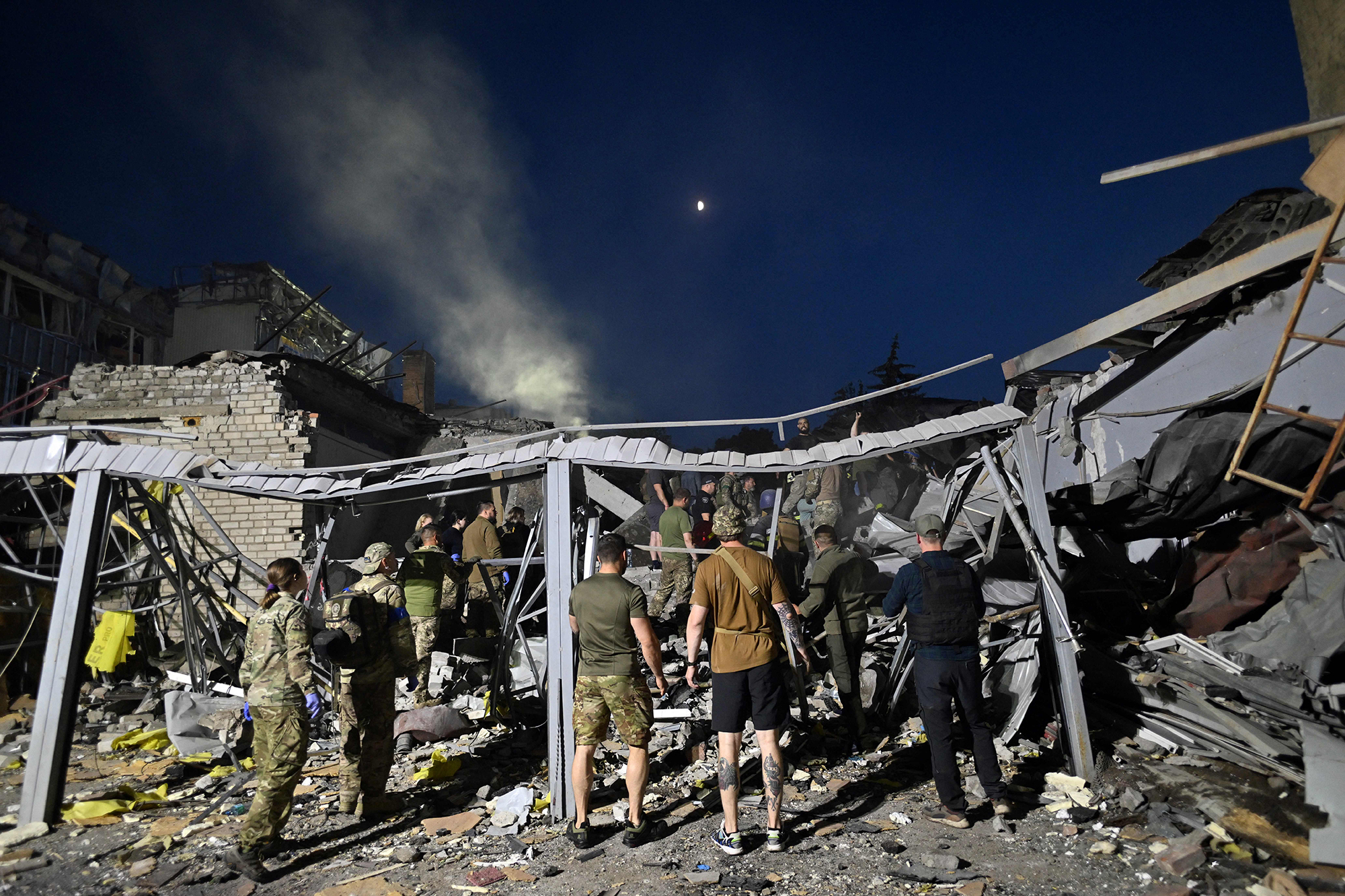 Rescuers and volunteers work to rescue people from under the rubble after a Russian missile strike in Kramatorsk, Ukraine, on June 27. 