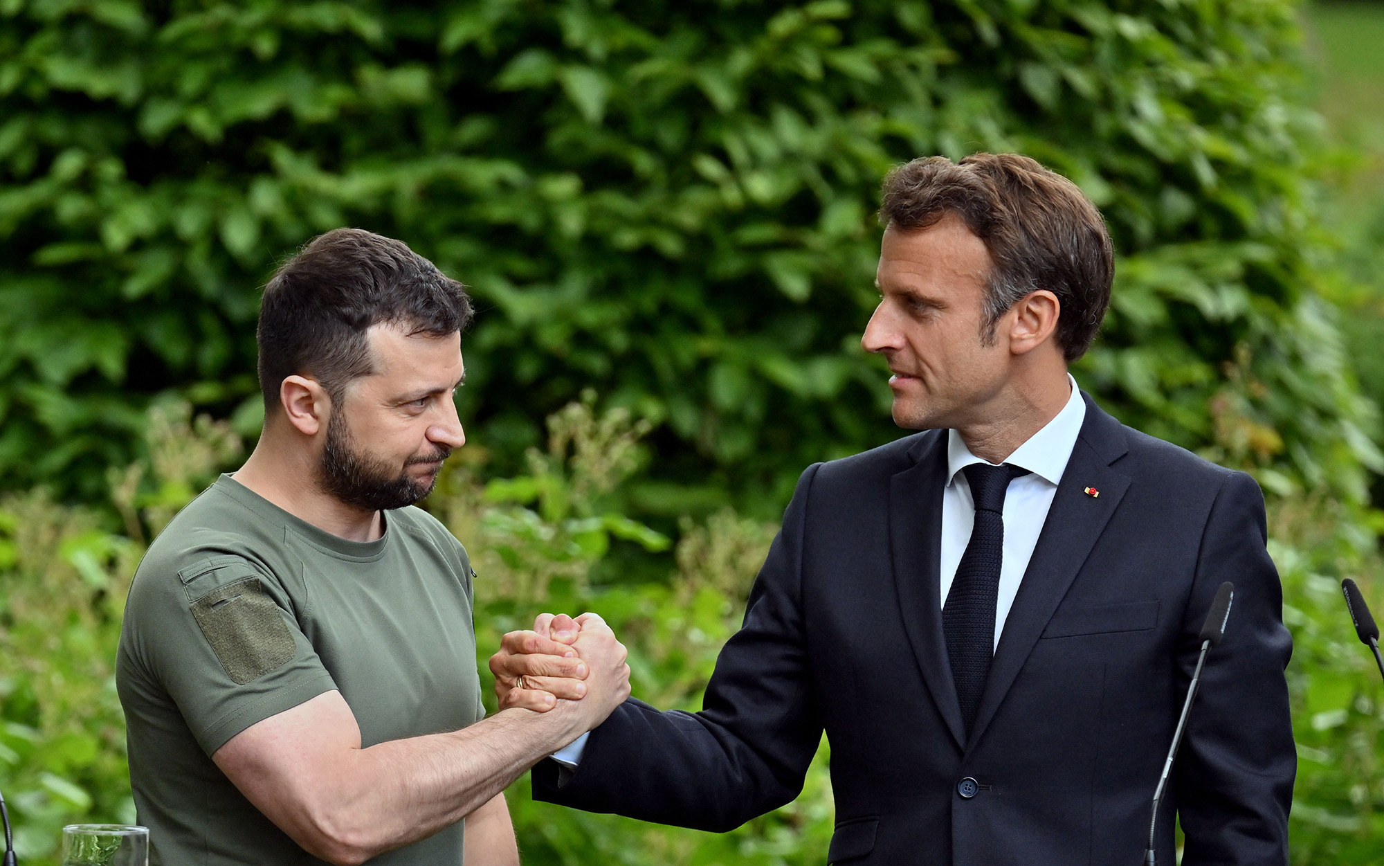 Ukrainian President Volodymyr Zelensky, left, and French President Emmanuel Macron shake hands after giving a news conference in Kyiv, Ukraine, on June 16.