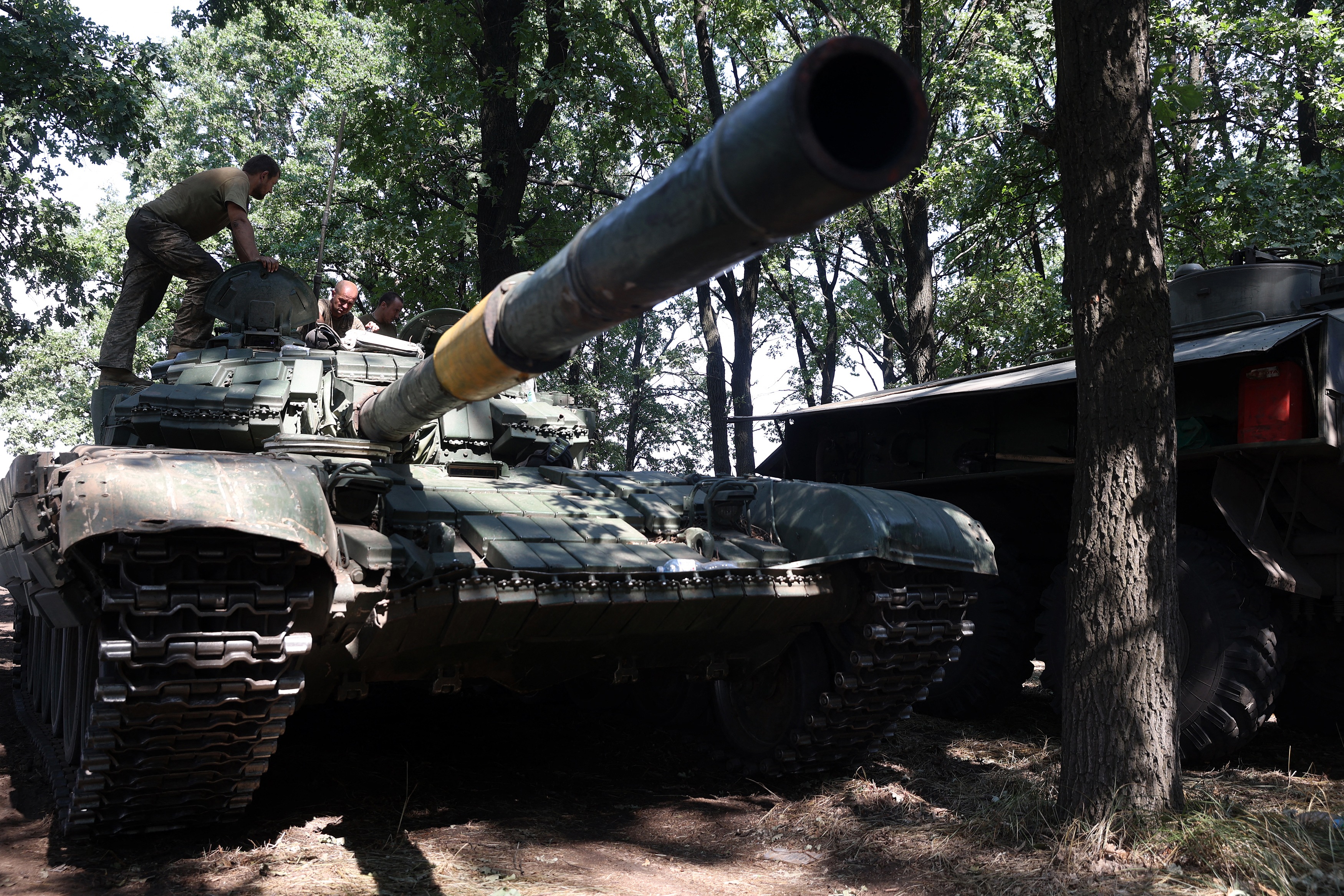 Ukrainian soldiers stand on a tank at the front line in the Donetsk region of Ukraine on August 19. 