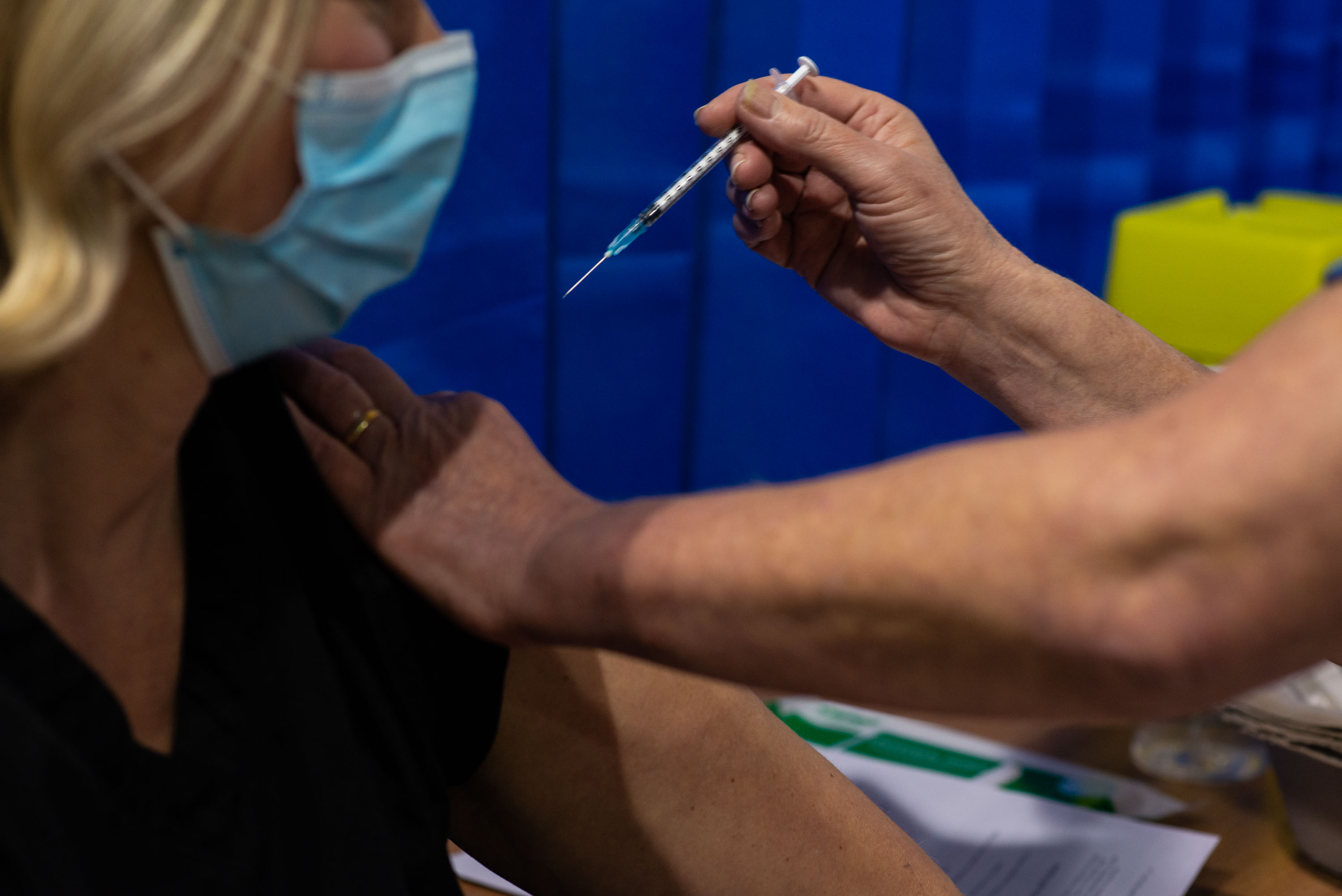 A patient receives the Pfizer/BioNTech Covid-19 vaccine as the UK vaccination rollout gets underway at a health center in Cardiff, Wales, on Tuesday, December 8.