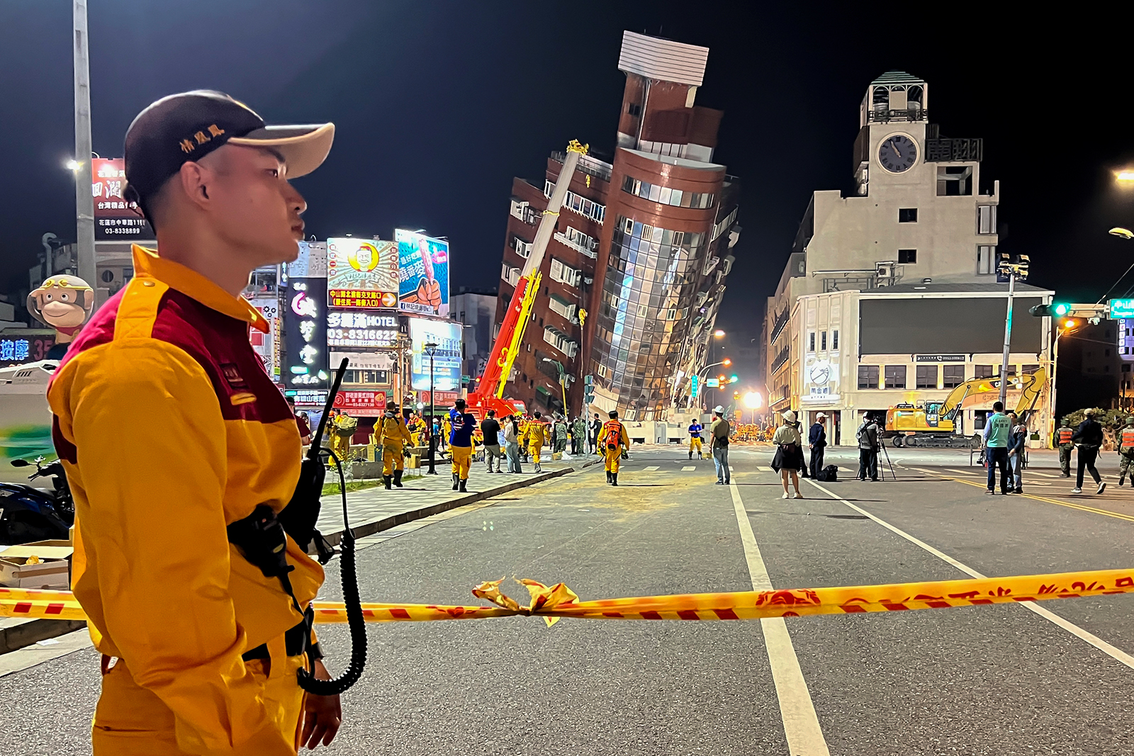 A rescue worker stands near the cordoned off site of a leaning building in the aftermath of an earthquake in Hualien, eastern Taiwan on Wednesday, April 3.